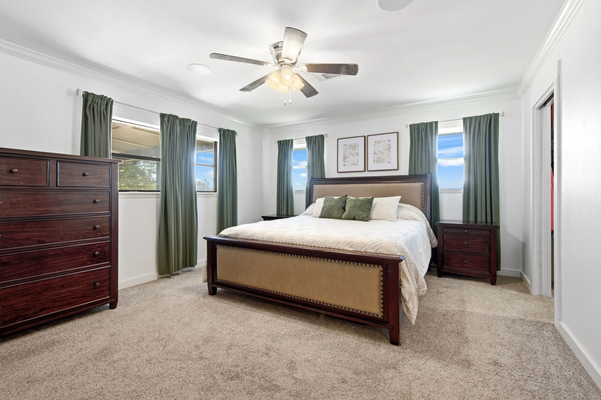 Primary bedroom with recessed lighting, ceiling fan, carpeted flooring, and crown molding
