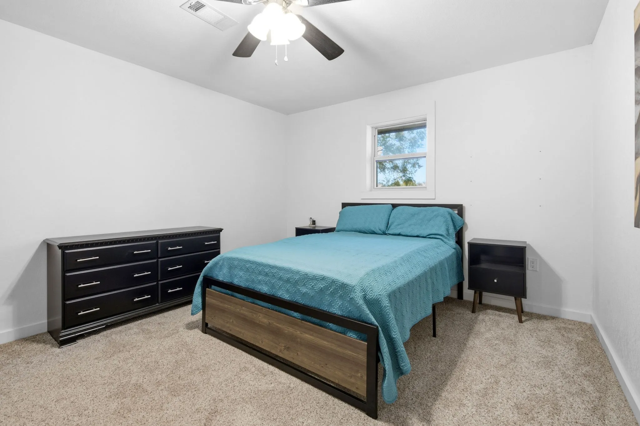 Carpeted bedroom room featuring white walls, a ceiling fan, and closet
