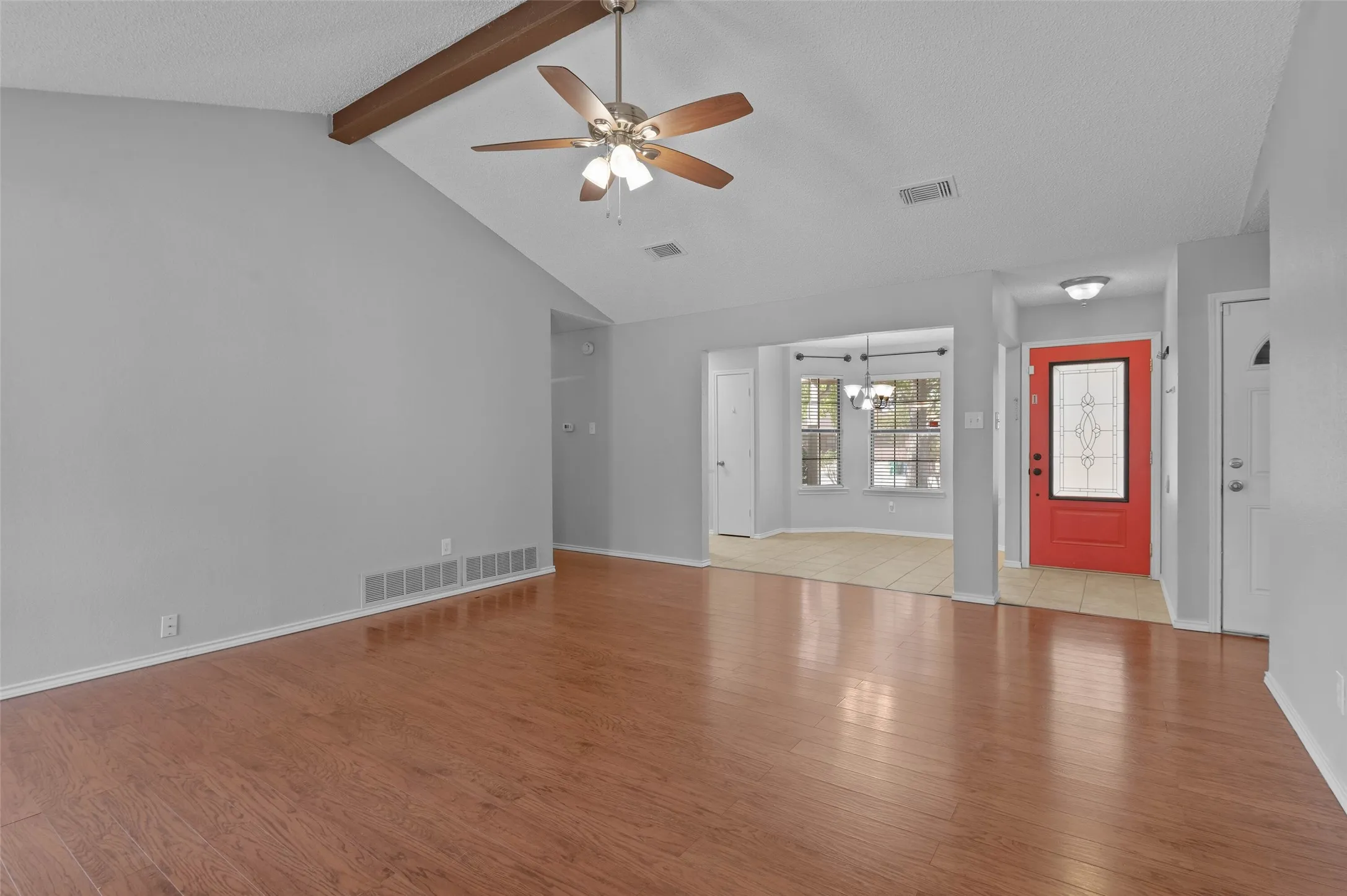 Living room with view of dining area and front entry