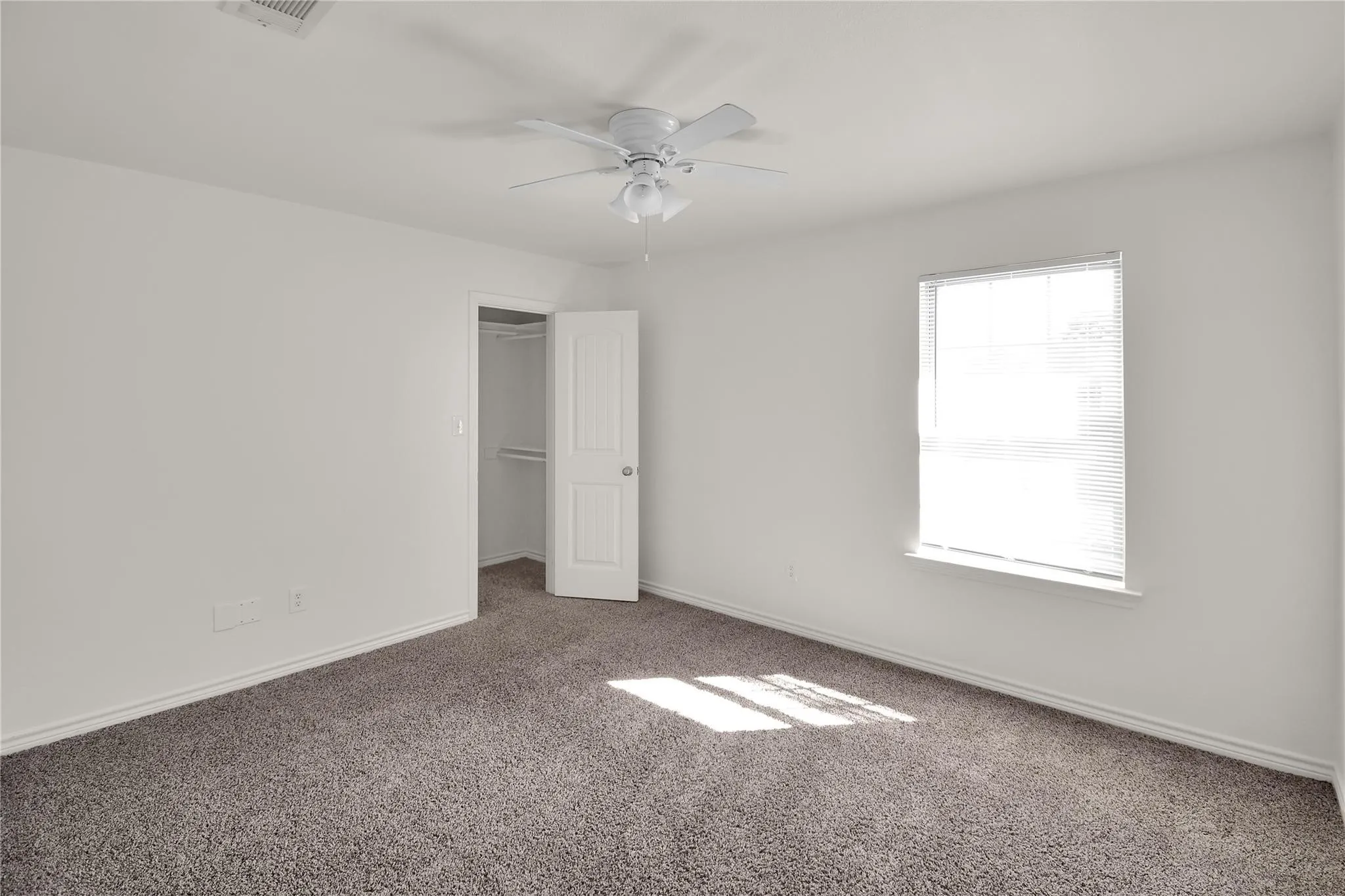 Neutral-toned carpeting complements the white walls