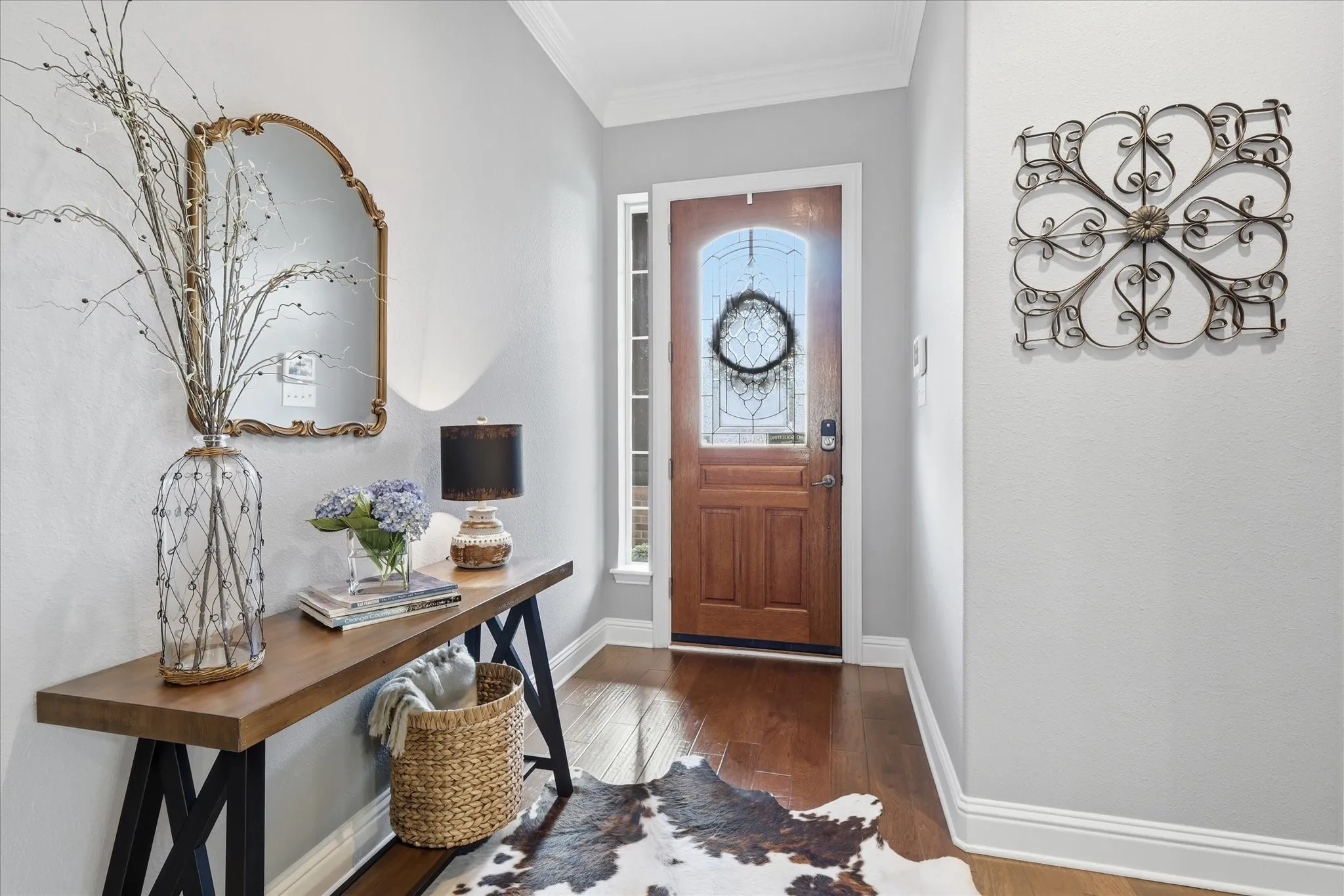Step inside to a bright, welcoming entry where rich hardwood floors and elegant finishes set the tone for the home.