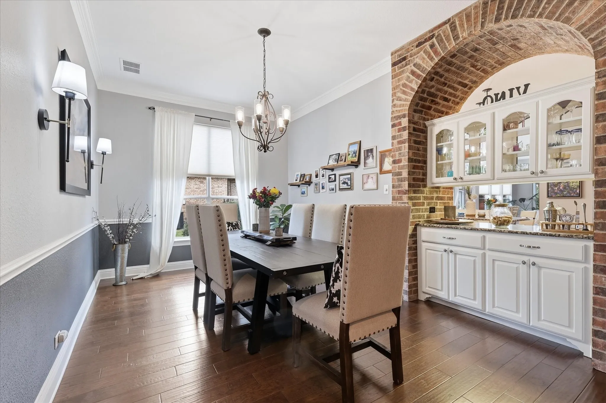 Made for memorable dinners and holiday gatherings, this elegant dining room is framed by one of the home’s signature brick archways.