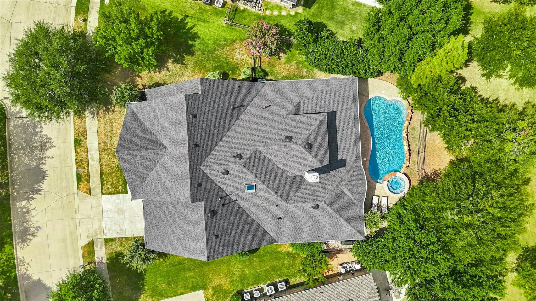An aerial perspective showcases the home’s generous footprint, backyard pool and spa, and premium placement along the course.