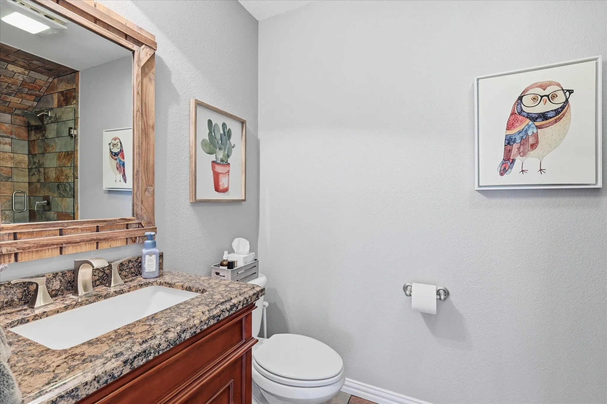 A stylish secondary bath with granite counters and a beautifully tiled walk-in shower adds another touch of quality throughout the home.