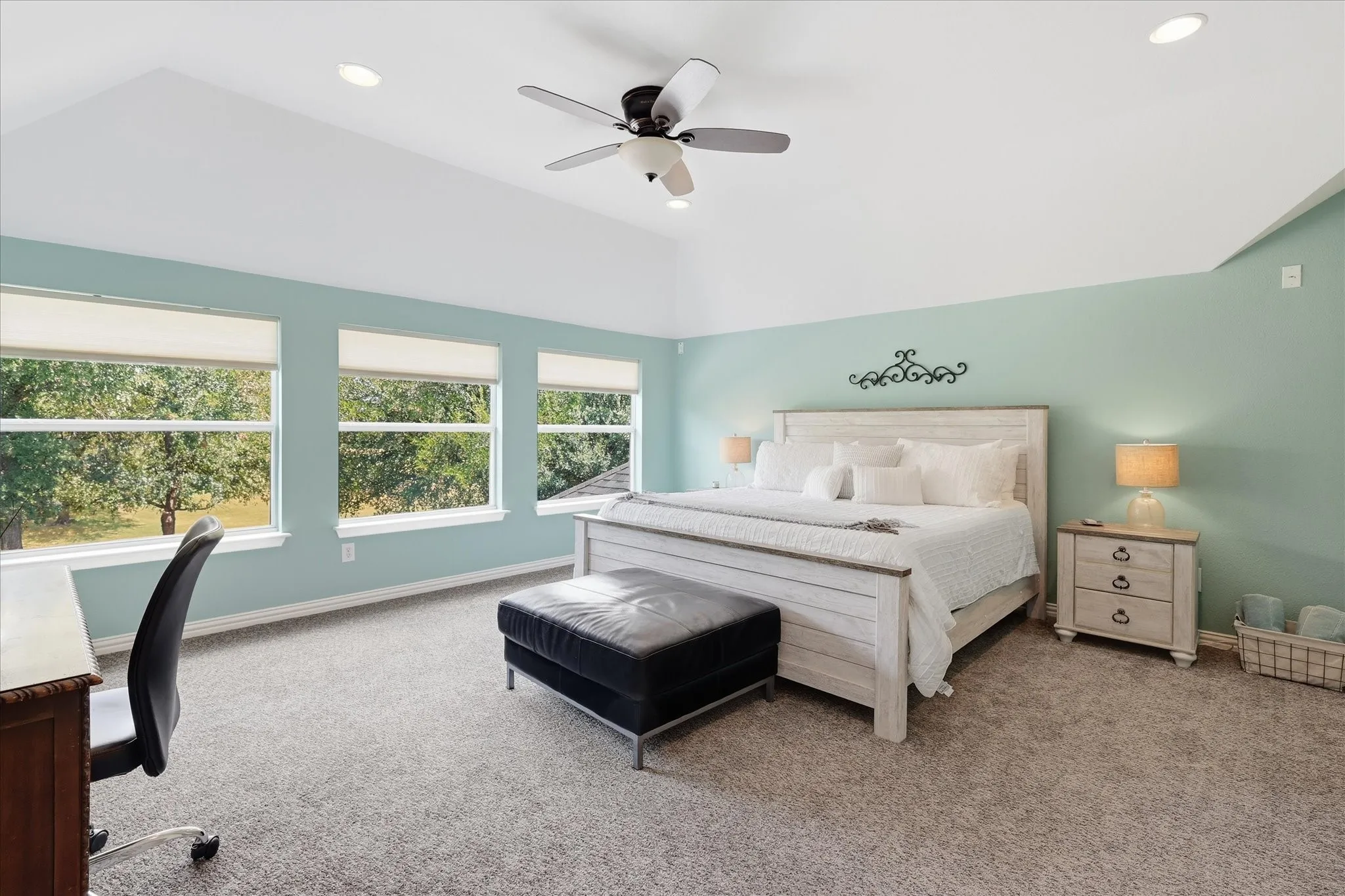 Generously sized and flooded with natural light, this upstairs bedroom feels more like a second primary suite than a secondary bedroom.