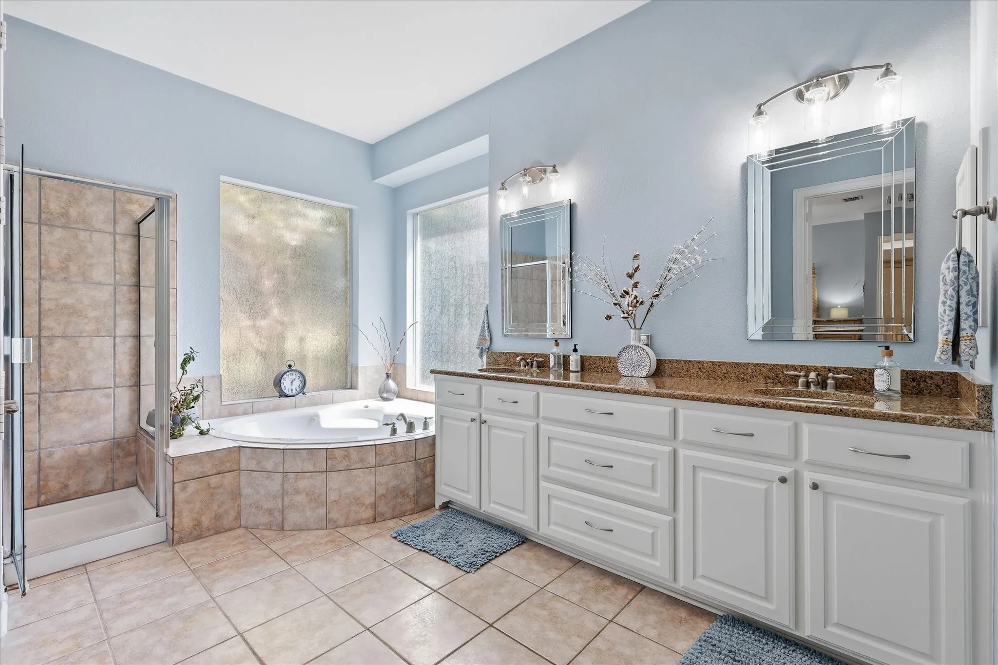 Your own private retreat — a bright, spacious primary bath with dual vanities, soaking tub, separate shower, and incredible natural light.