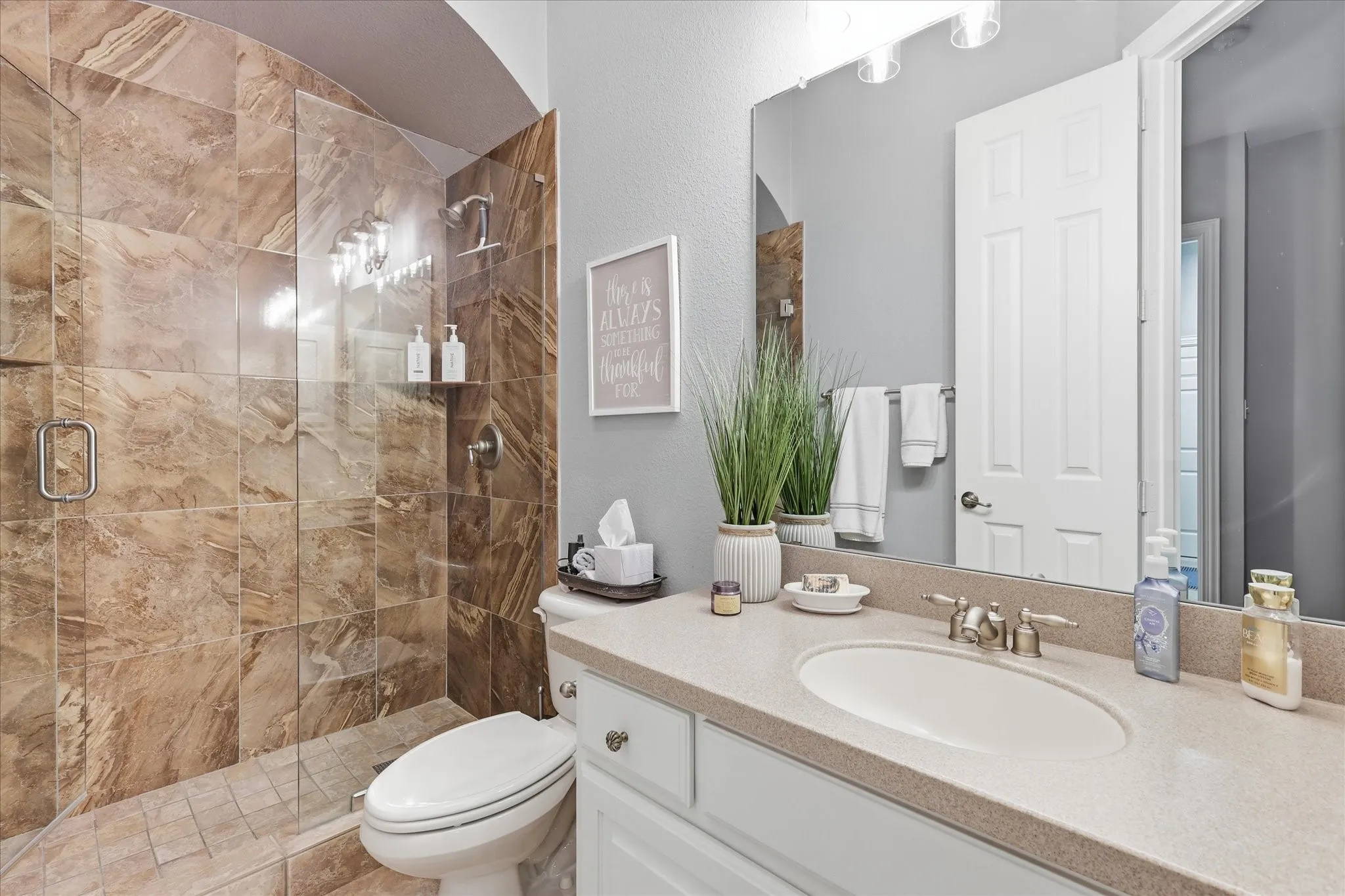 Beautifully finished with a dramatic tiled walk-in shower, this lovely bath gives guests or family their own polished, private space.