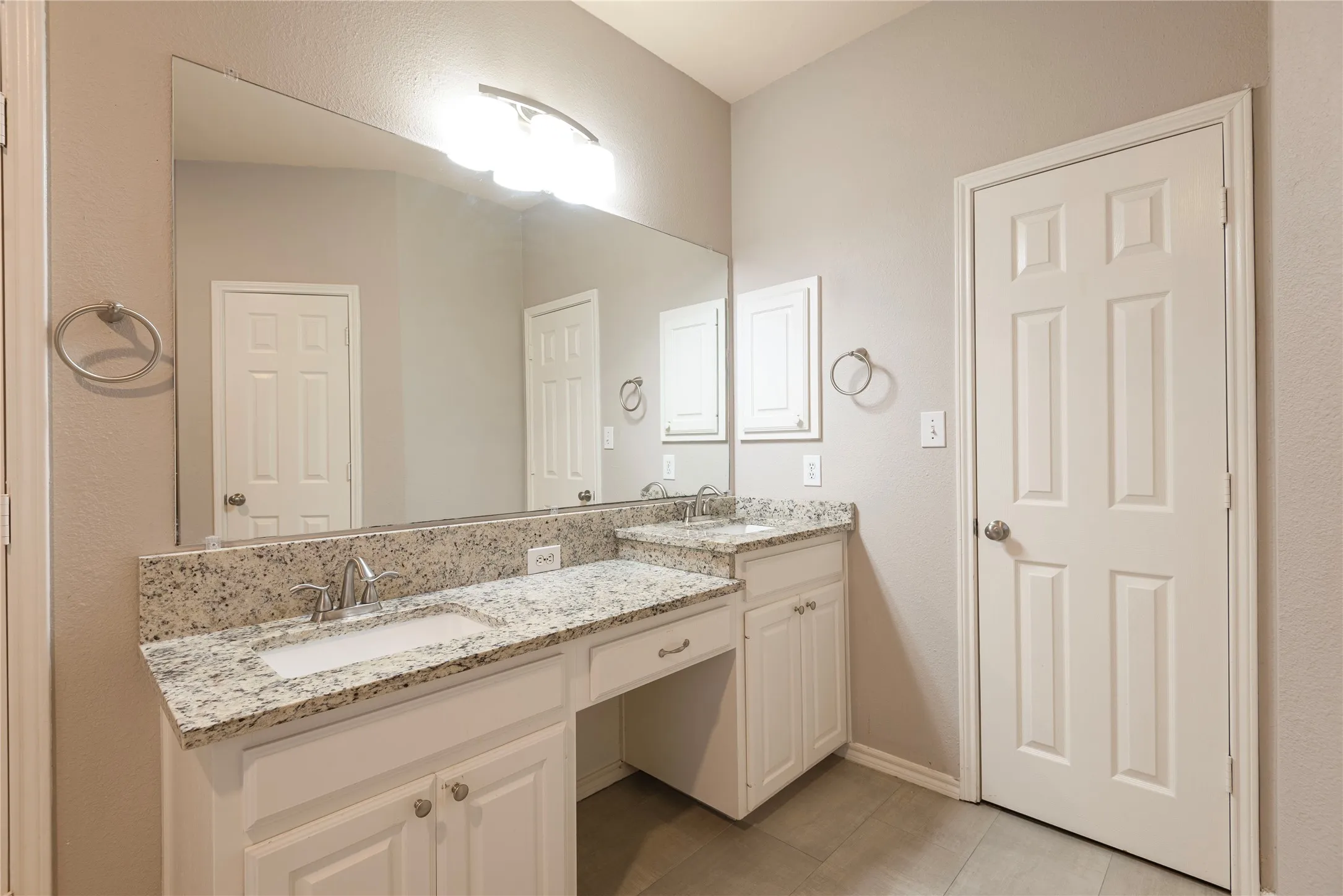 Bathroom featuring tile patterned floors and vanity