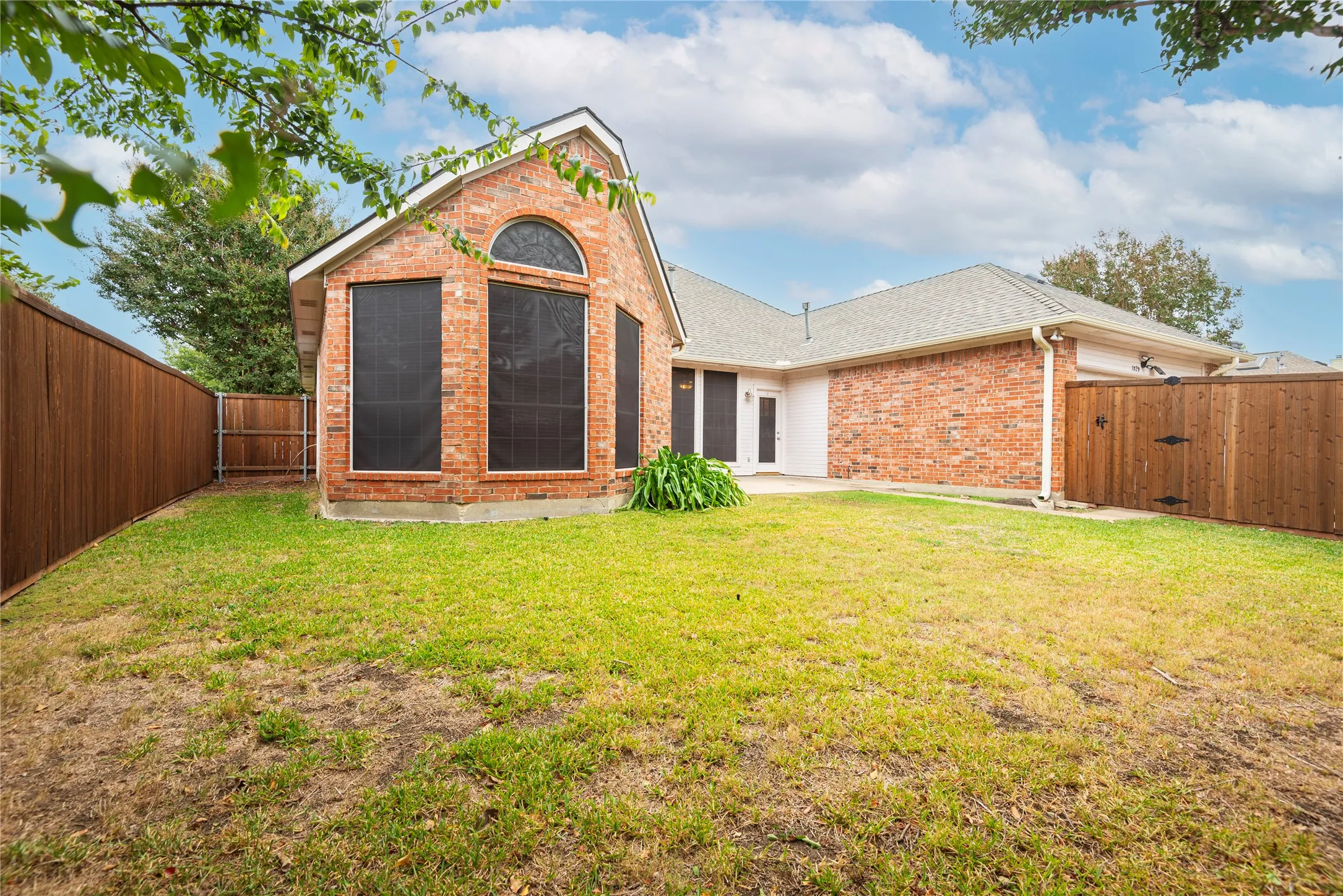 Rear view of house featuring a yard and a patio