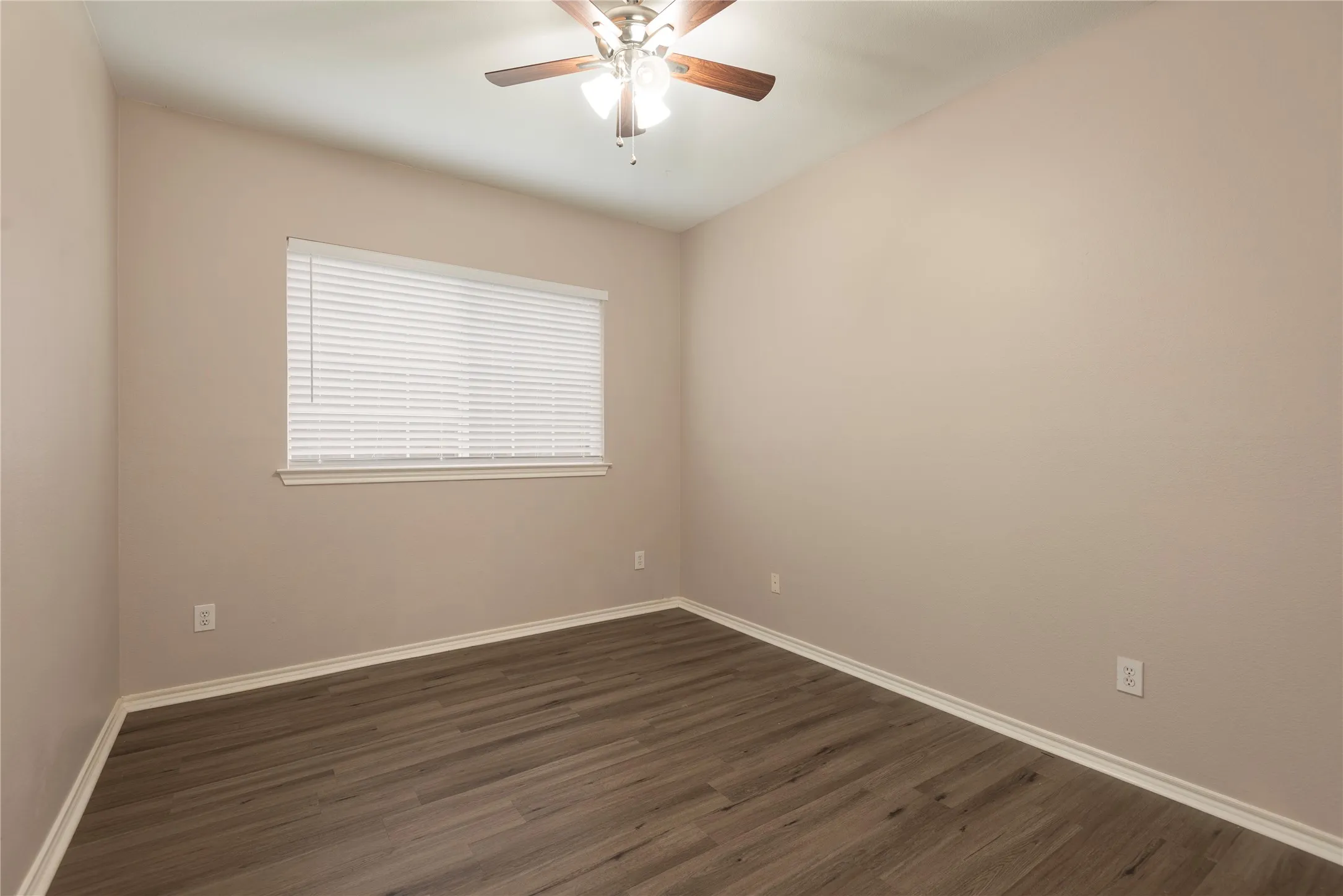 Spare room with ceiling fan and dark hardwood / wood-style flooring