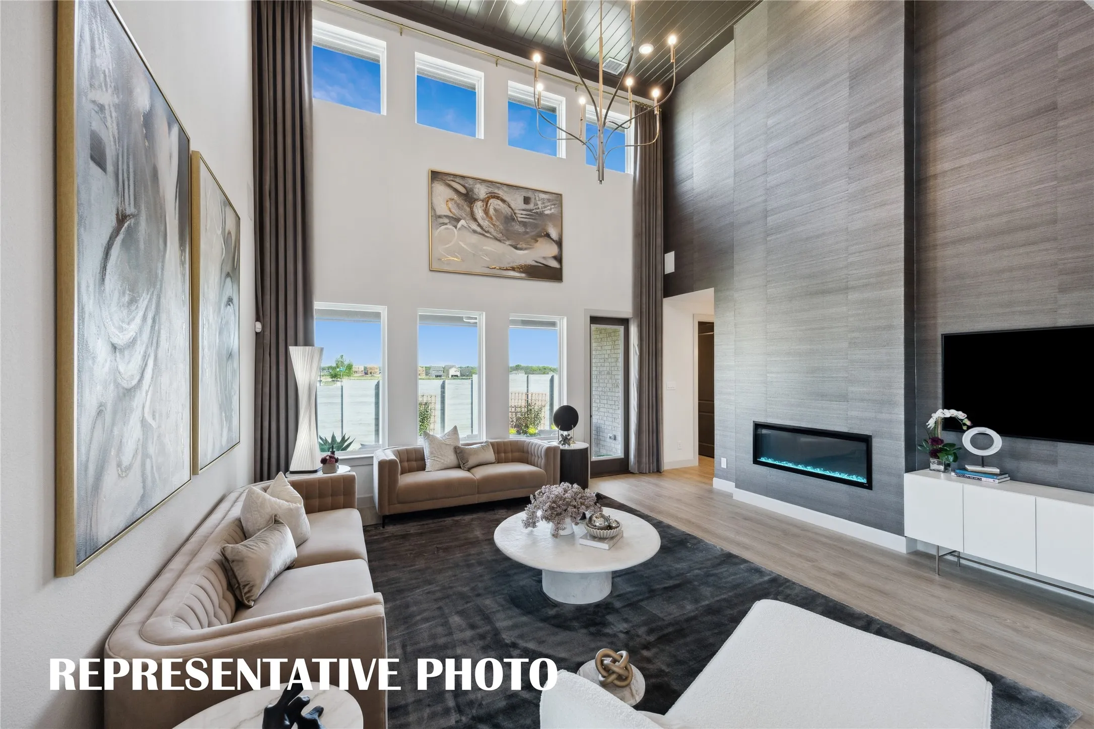 Dual story windows flood this family room with natural light!  REPRESENTATIVE PHOTO