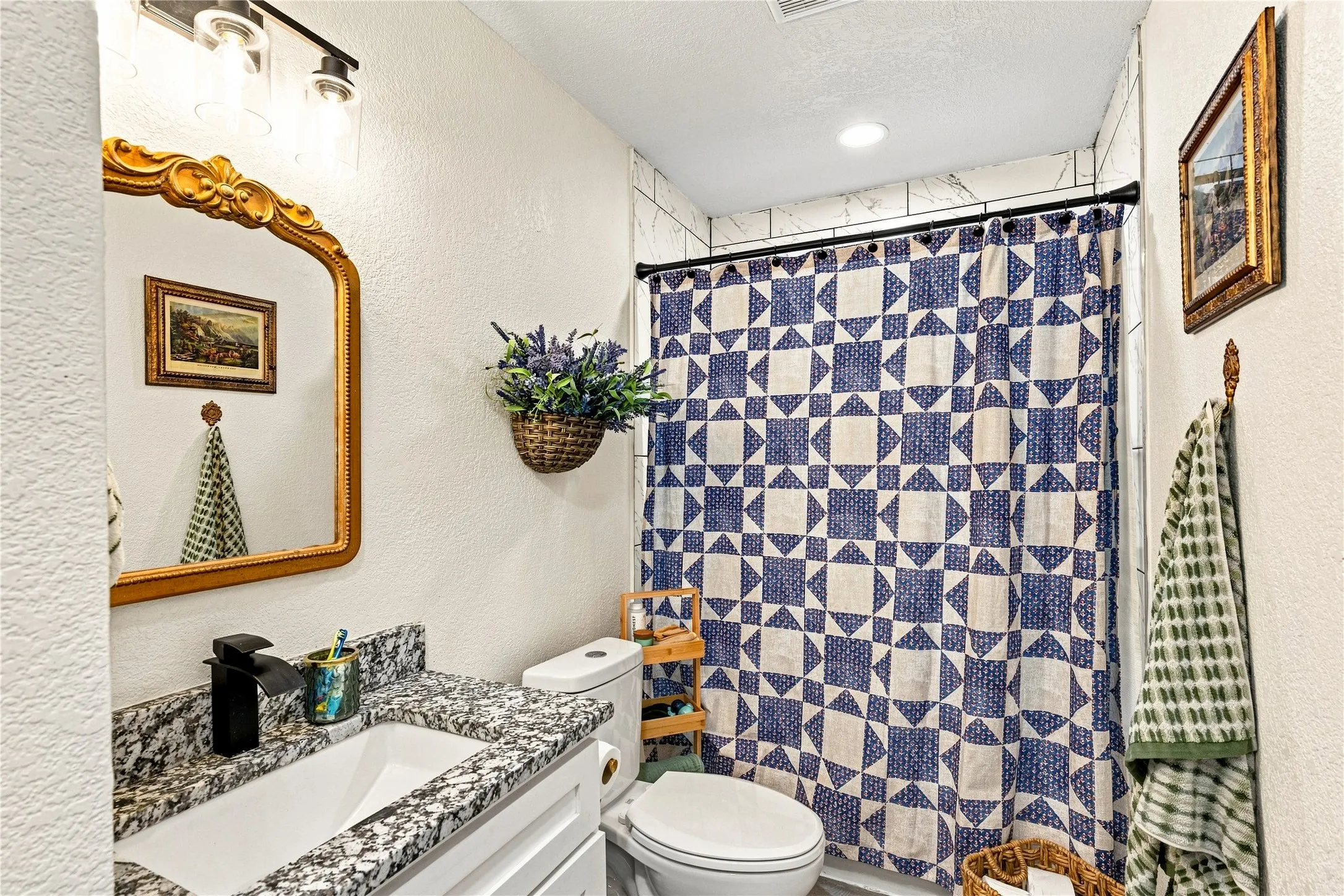 Vanity with a granite countertop, undermount sink, and matte black faucet