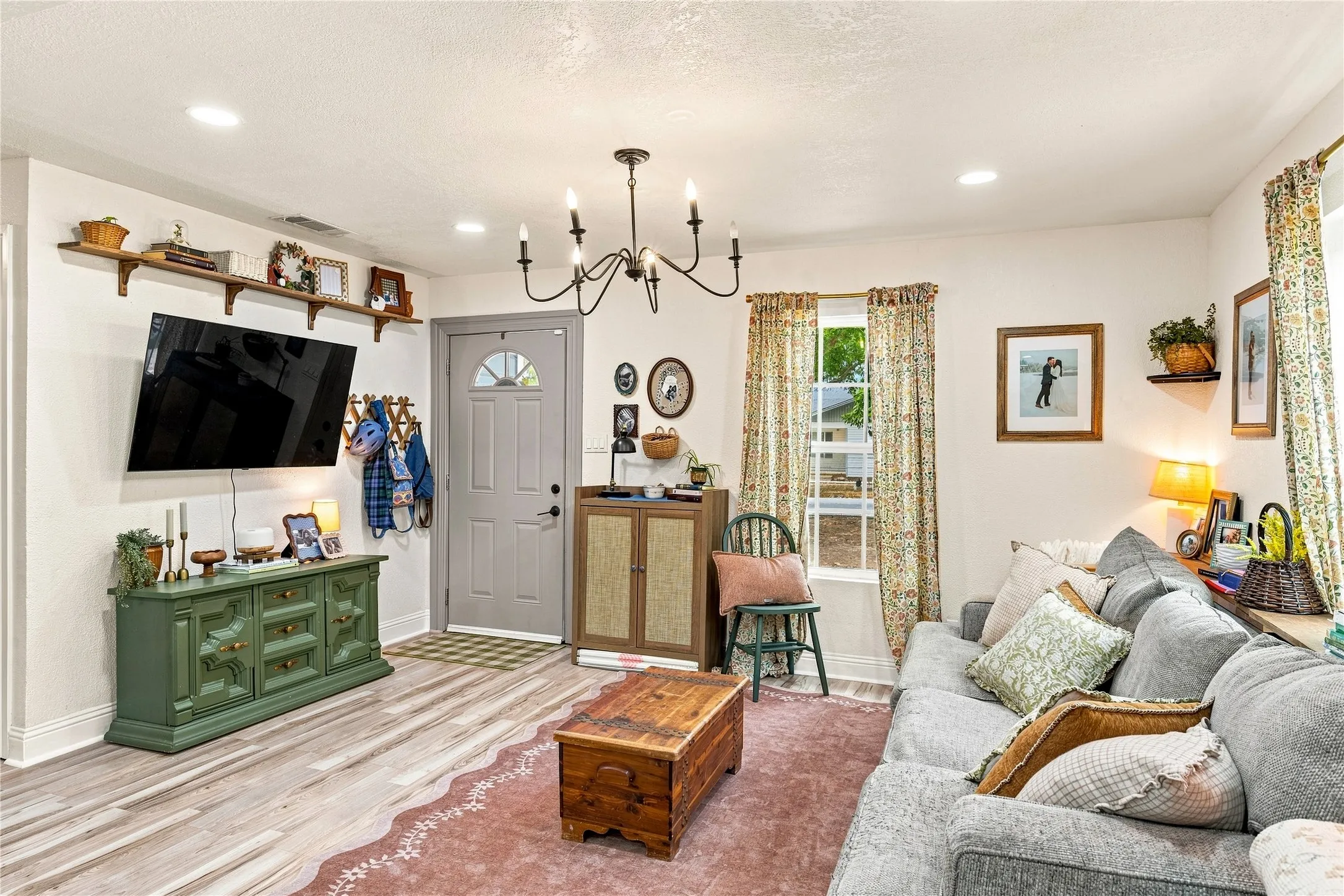 Wood-finish flooring, recessed lighting, and a chandelier with candelabra bulbs