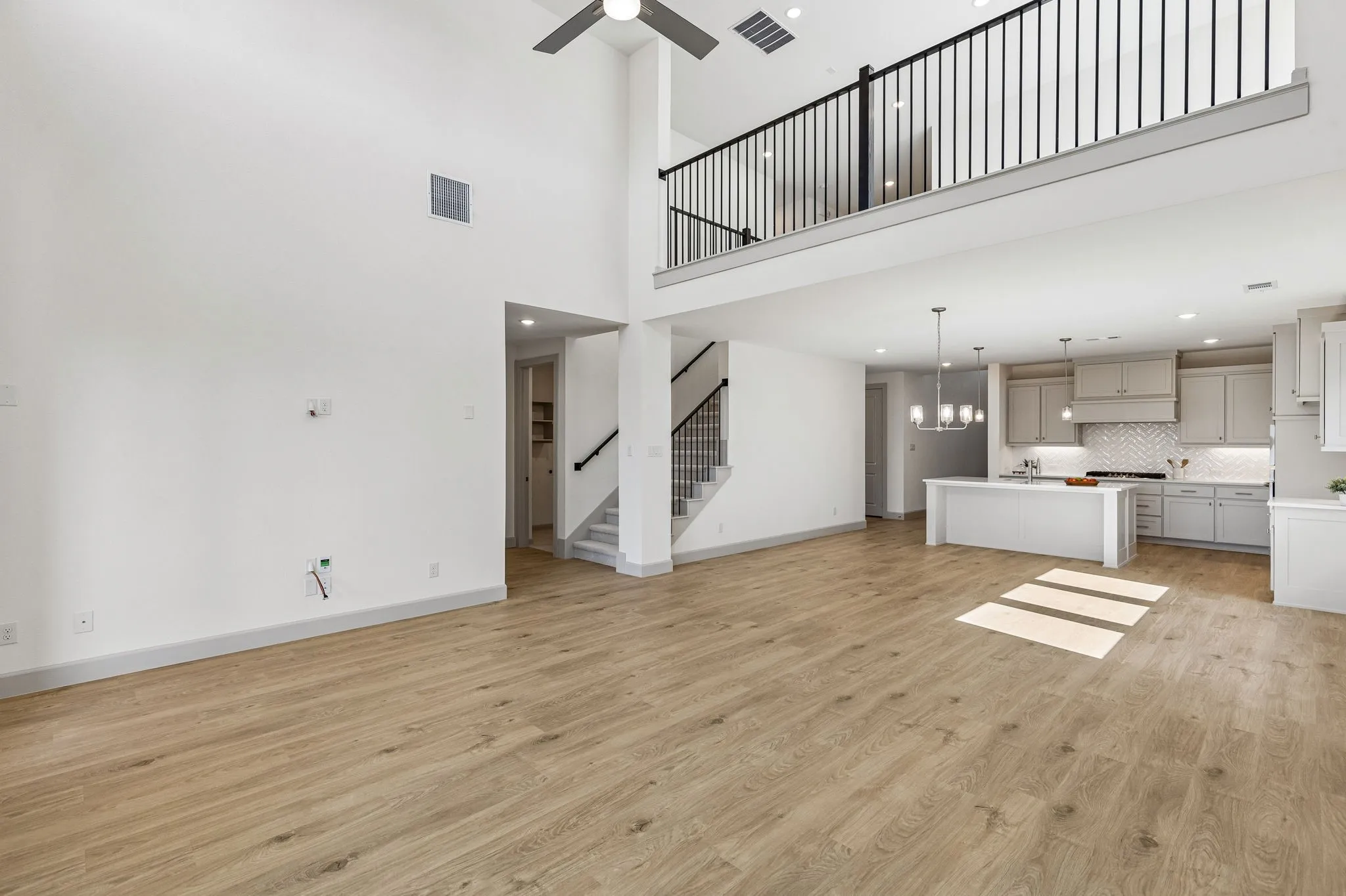 The family room is open to the game room upstairs creating multiple levels of open concept space for entertaining!