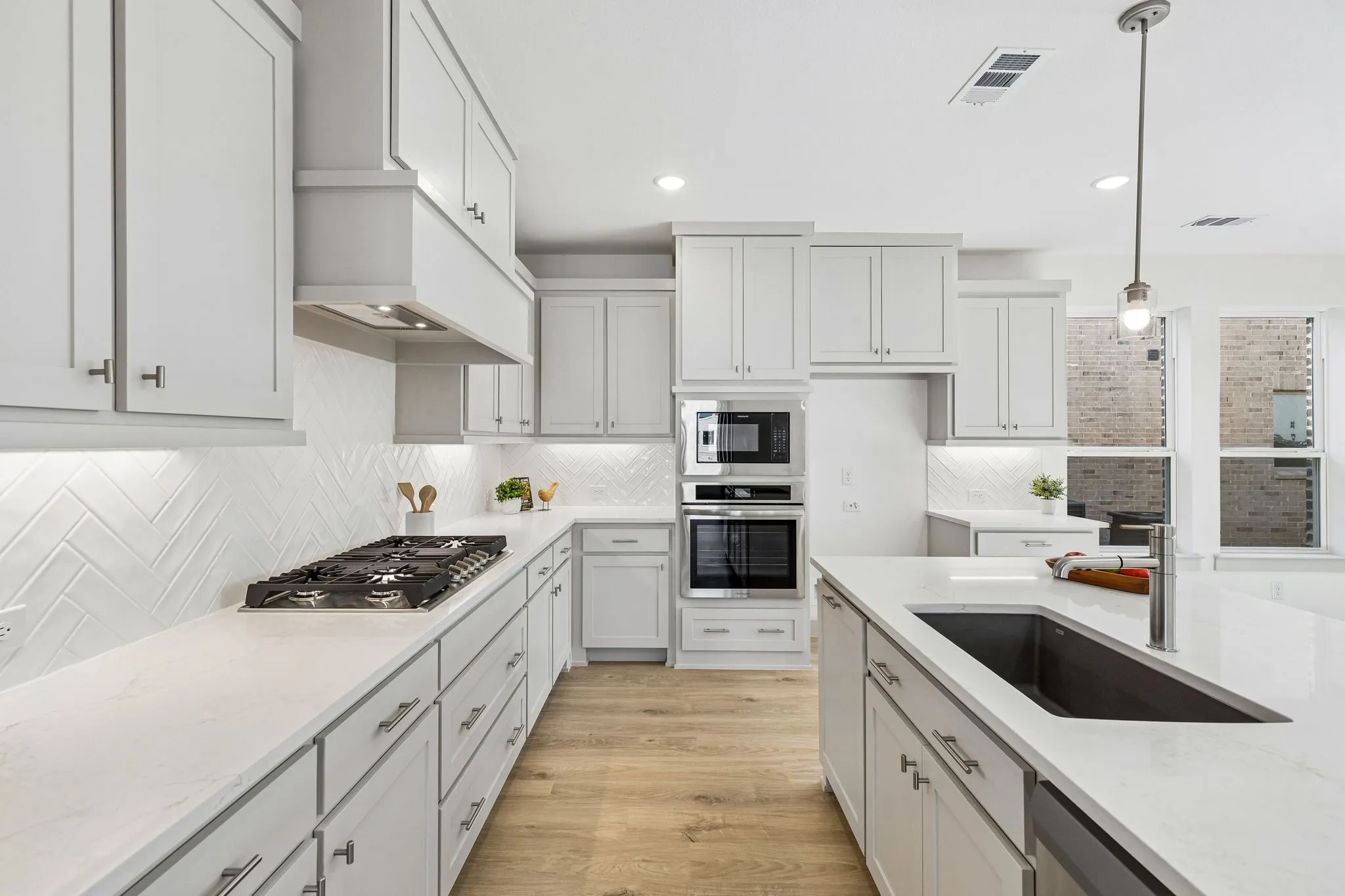 Beautiful cabinetry, gorgeous countertops and classic backsplash effortlessly pair with contemporary stainless steel to create a kitchen for the ages!