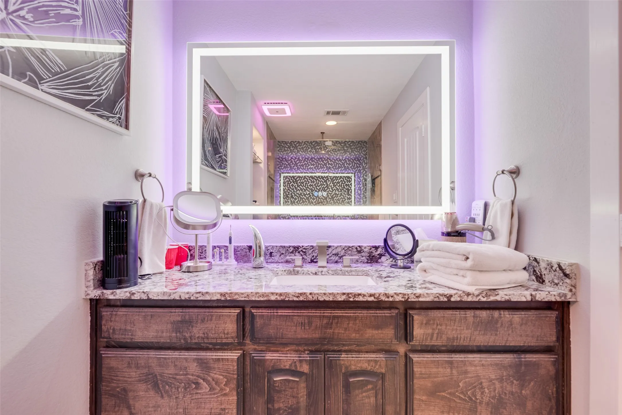 Bathroom featuring vanity and a shower