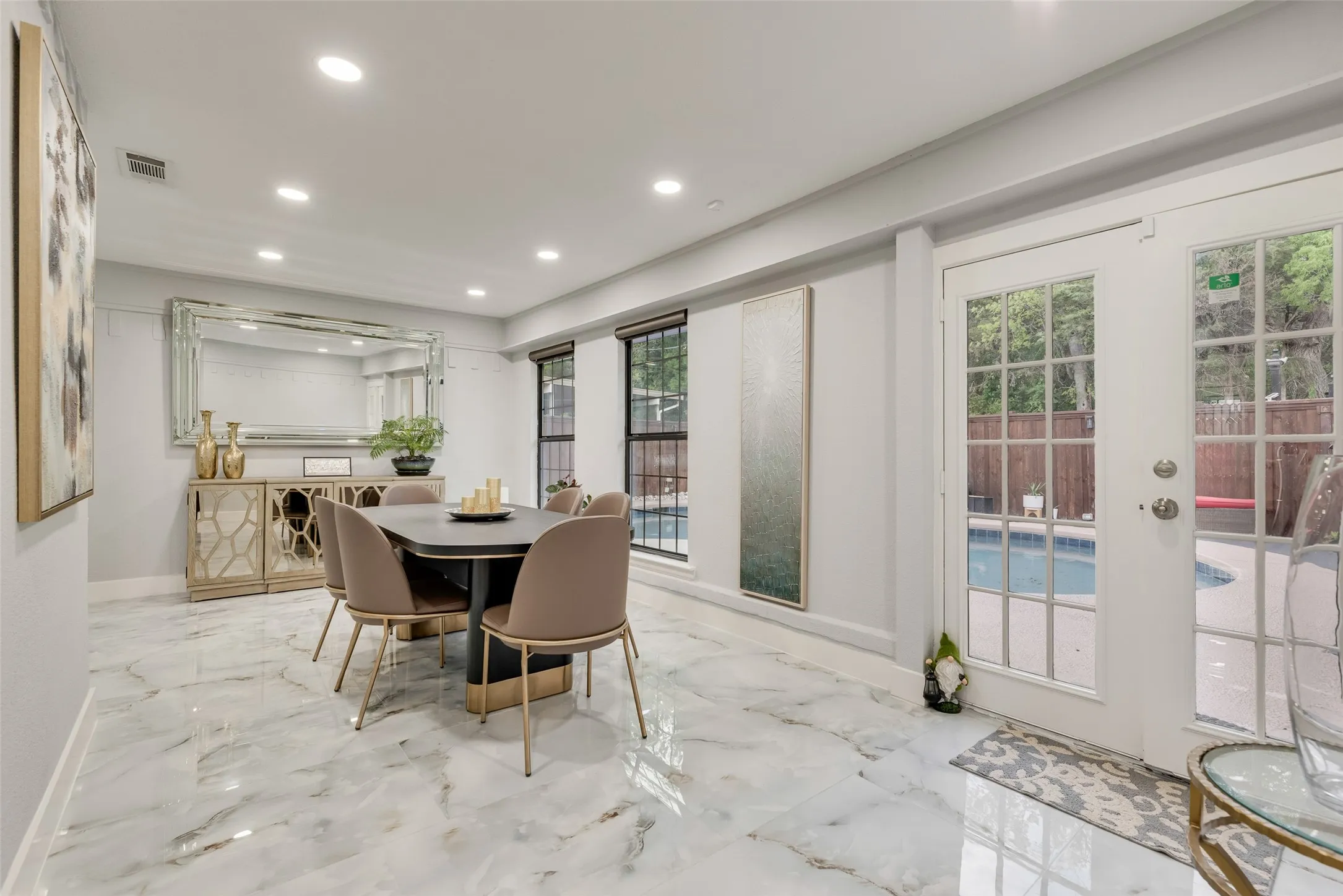 Dining room with recessed lighting, marble tiled floors, baseboards, and french doors