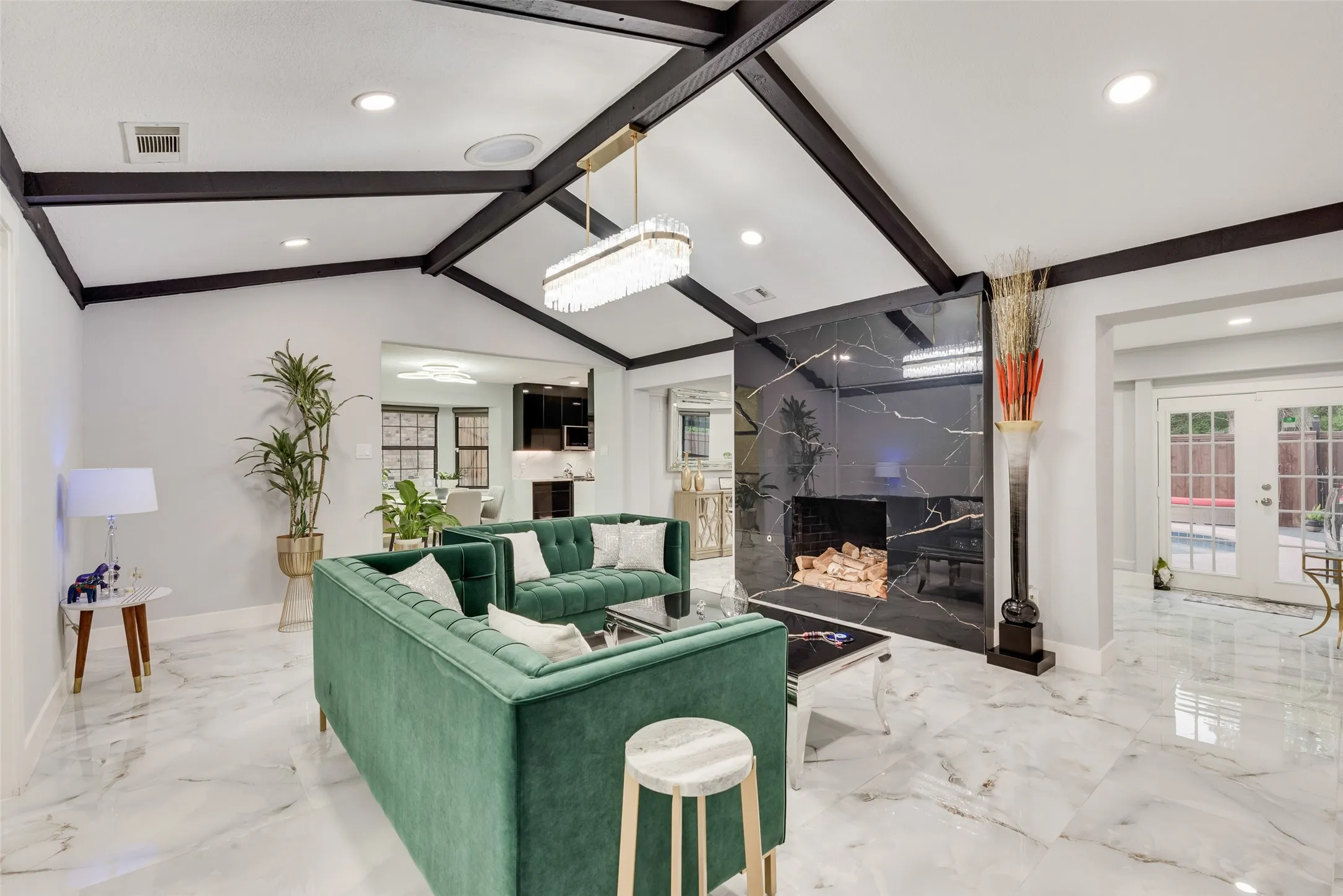 Living room with marble tiled flooring, a premium fireplace, baseboards, recessed lighting, and french doors