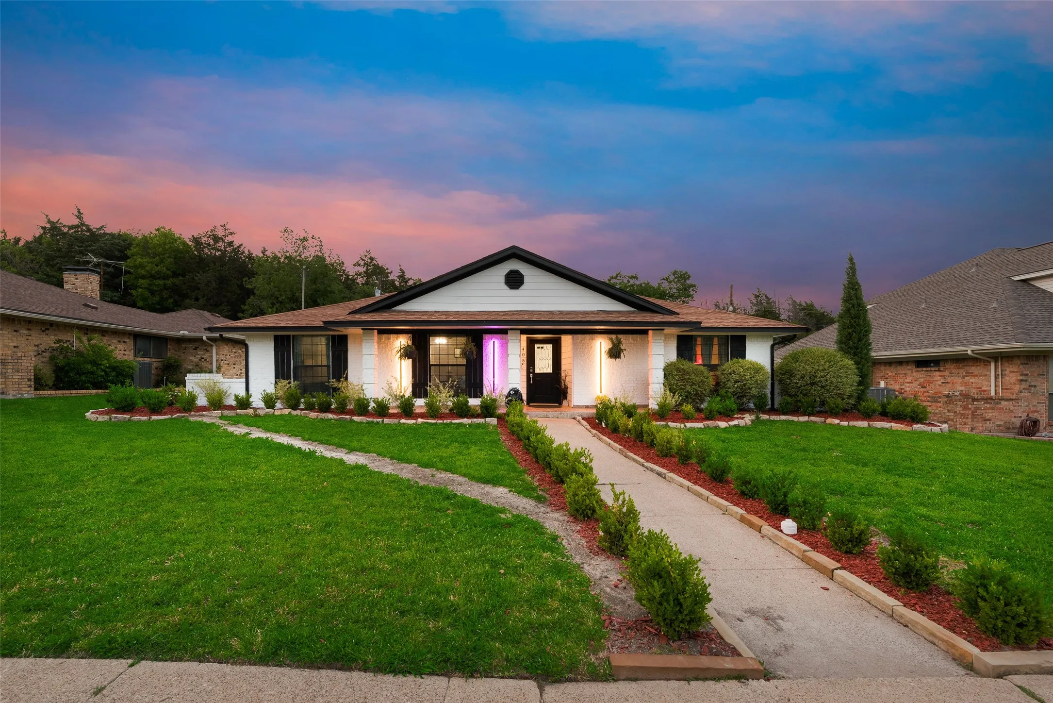 Ranch-style house featuring a front lawn, brick siding, and a porch