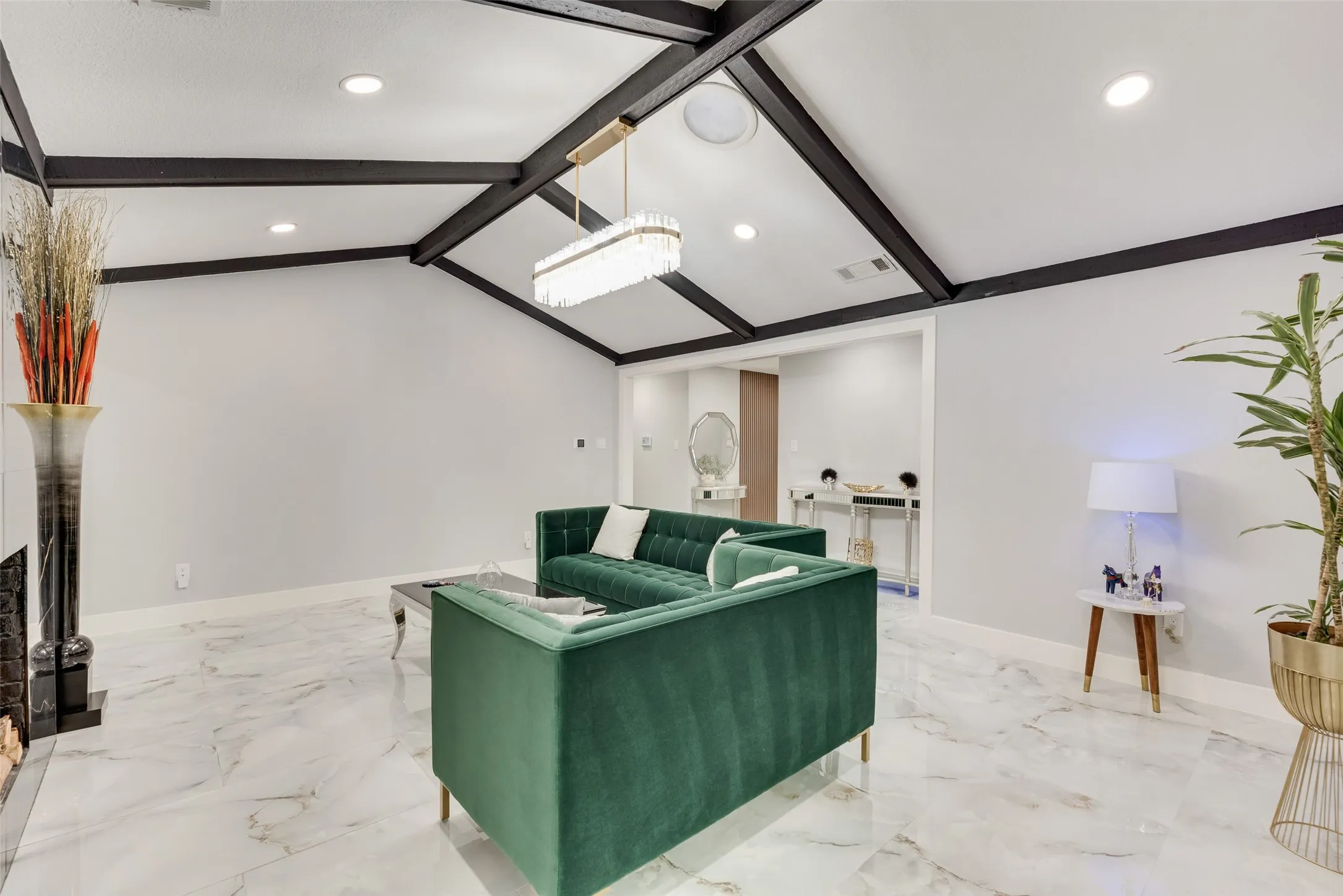 Living area with recessed lighting, baseboards, light marble finish flooring, and a fireplace
