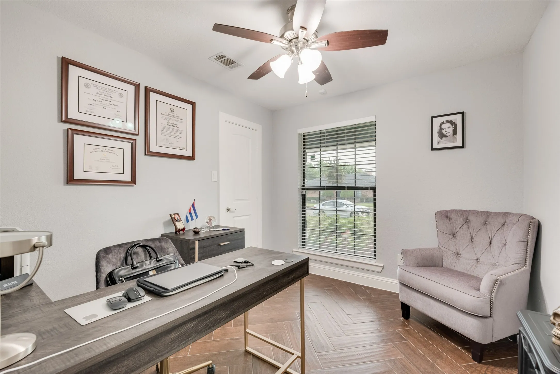 Home office with ceiling fan and baseboards