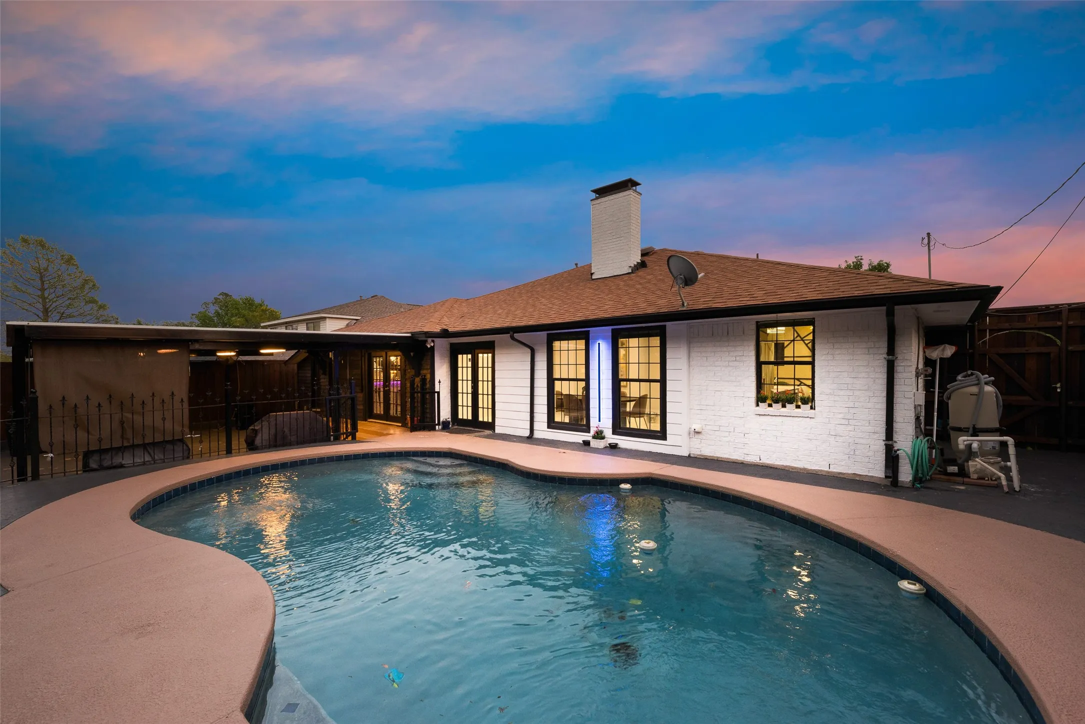 Swimming pool featuring a patio and fence