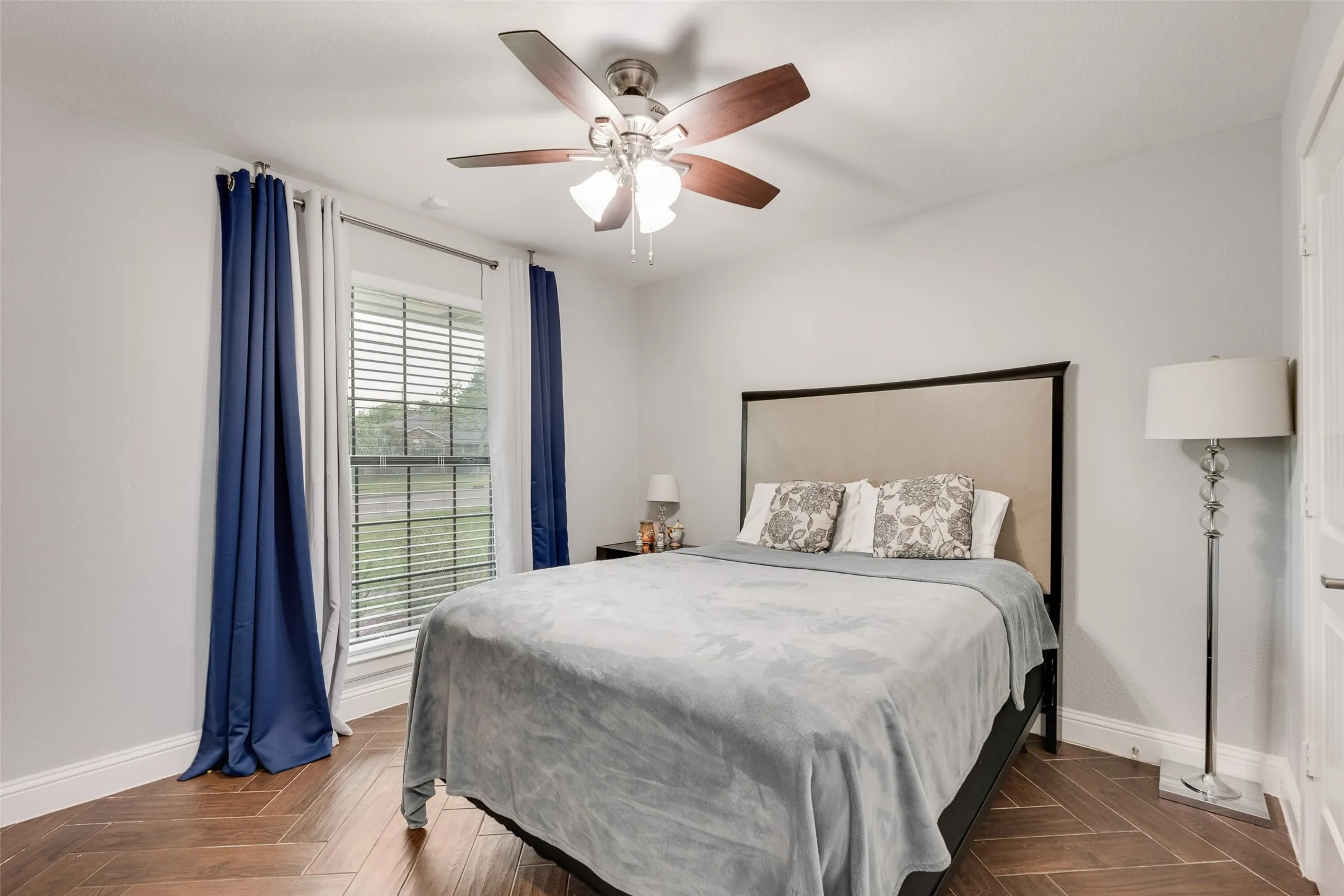 Bedroom with baseboards and a ceiling fan