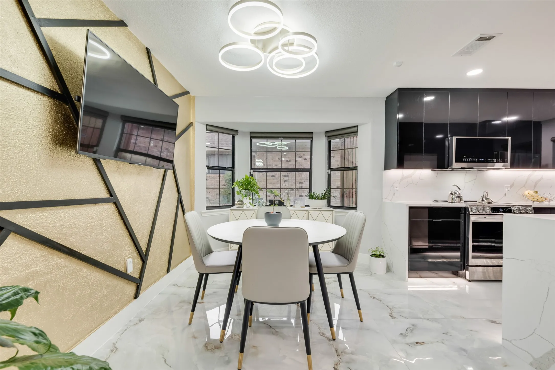Dining area featuring light marble finish flooring and a chandelier