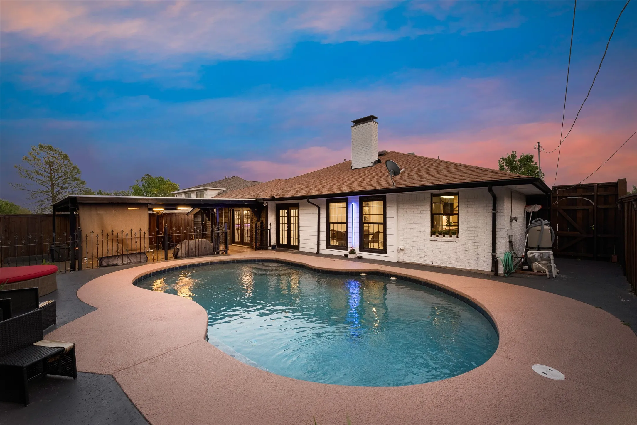 View of pool featuring a patio, a gate, and a fenced backyard