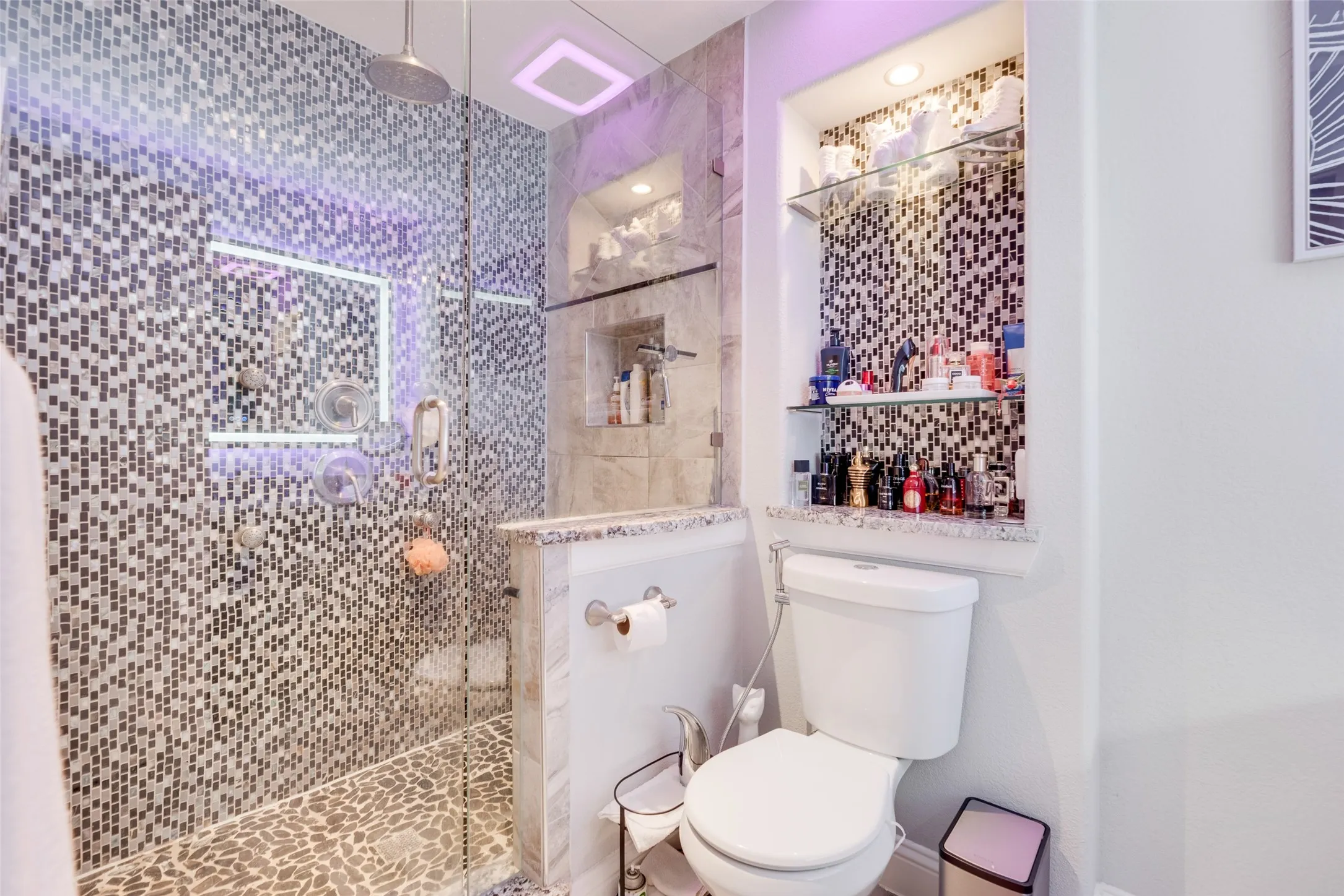 Bathroom featuring toilet and a walk in shower