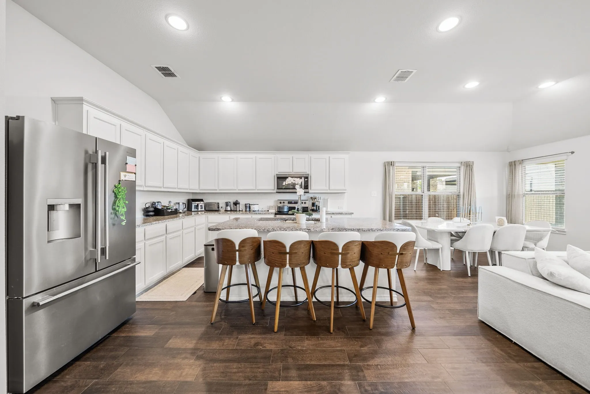 White cabinetry with a spacious island, stainless steel appliances, and recessed lighting