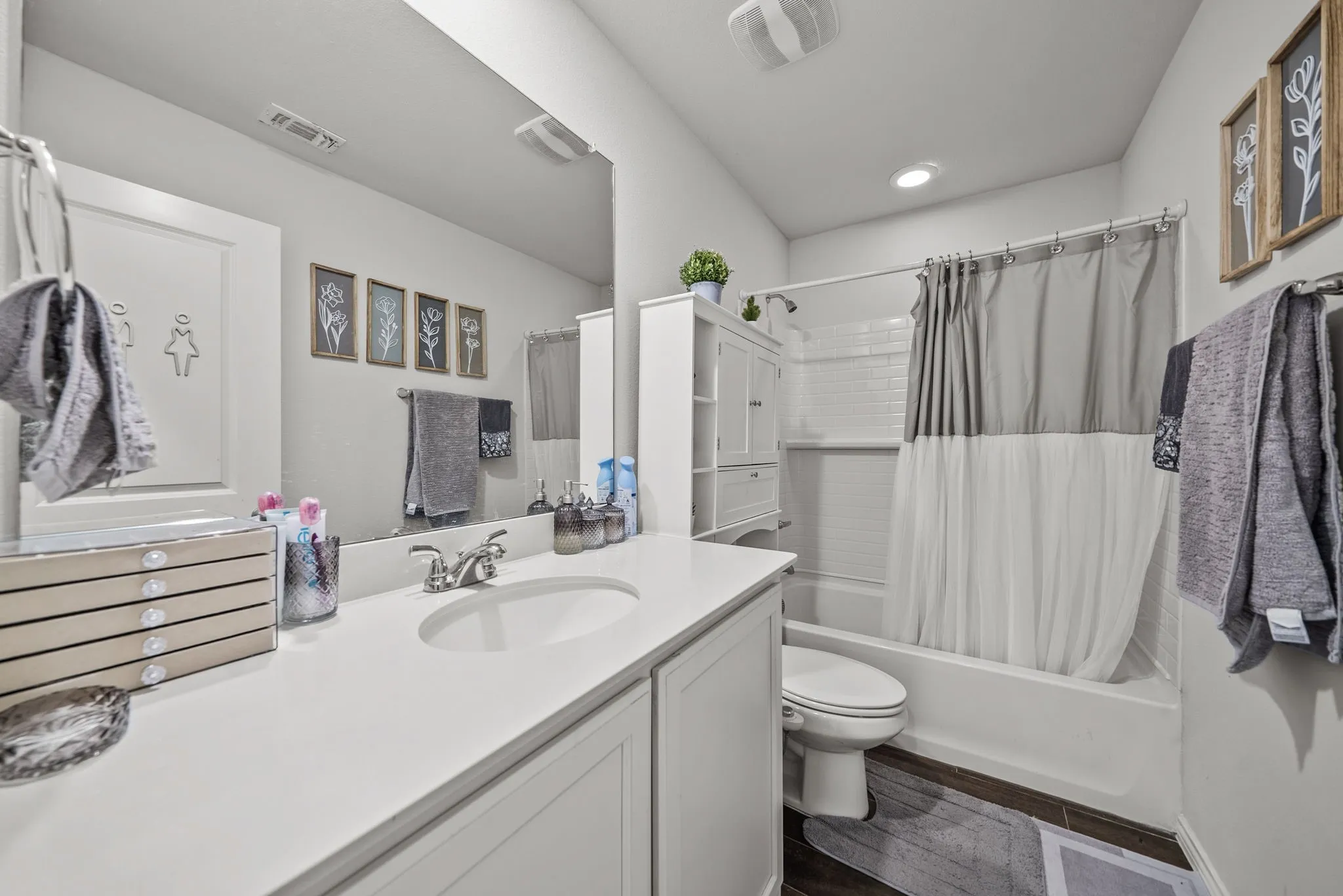 Vanity with an integrated sink, polished chrome faucet, and white countertop