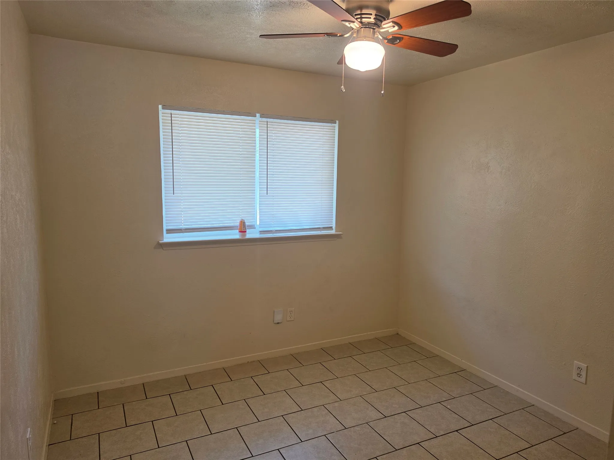 Neutral-toned walls complement the tiled flooring