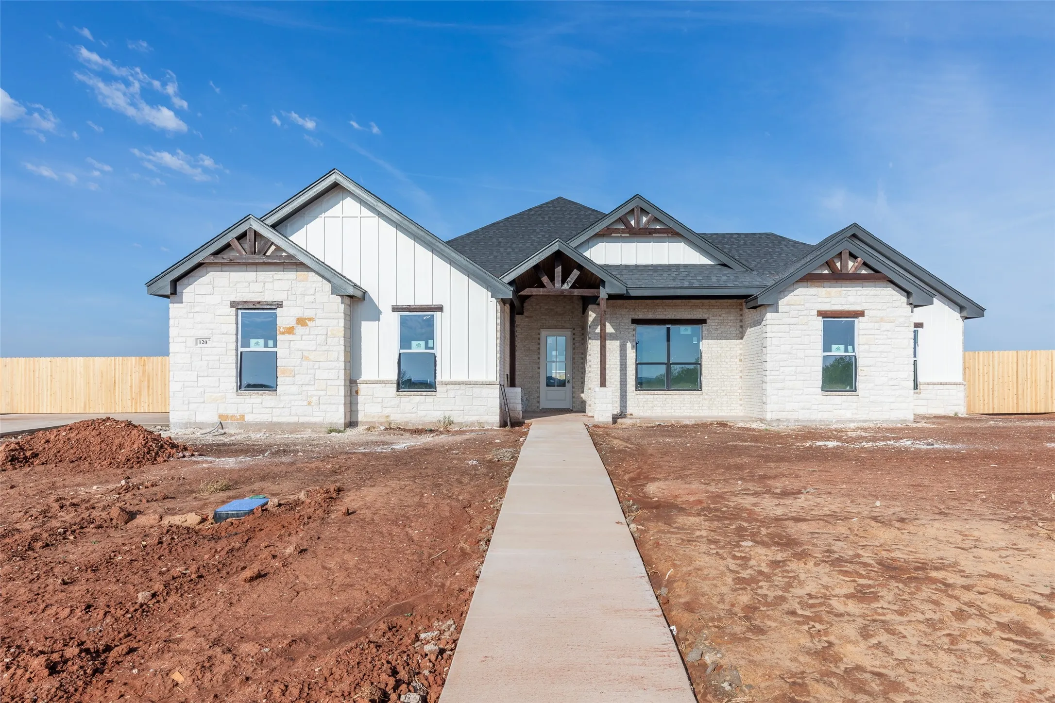 Contemporary exterior with light-colored stone and vertical siding accents