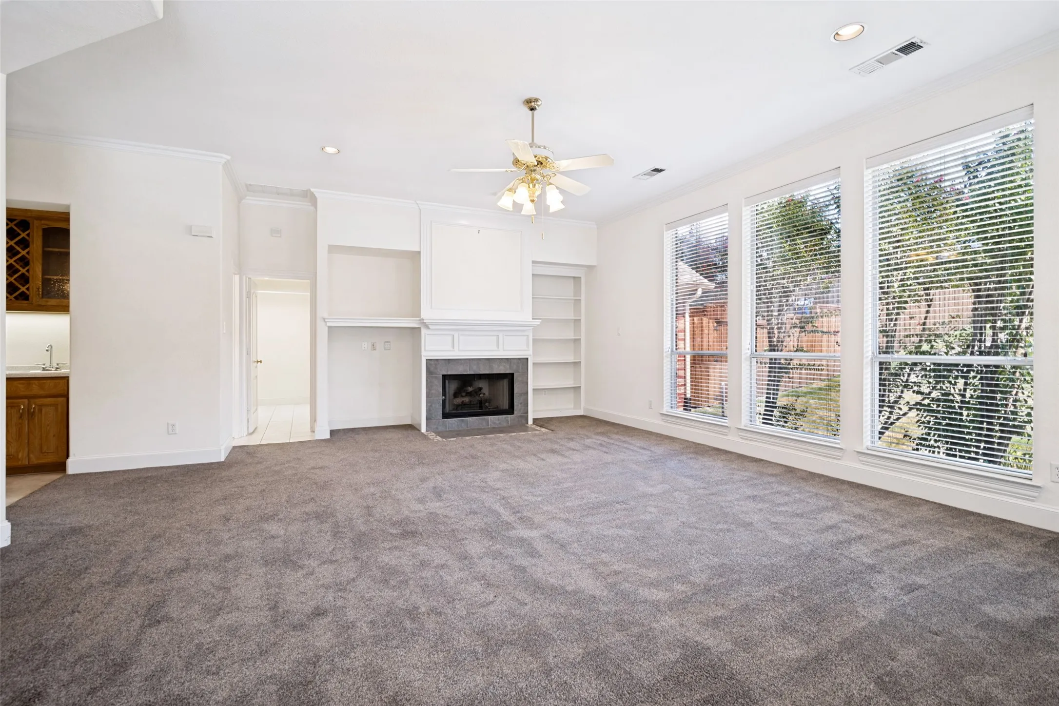 Lovely gas fireplace is accented by shelving and entertainment center.