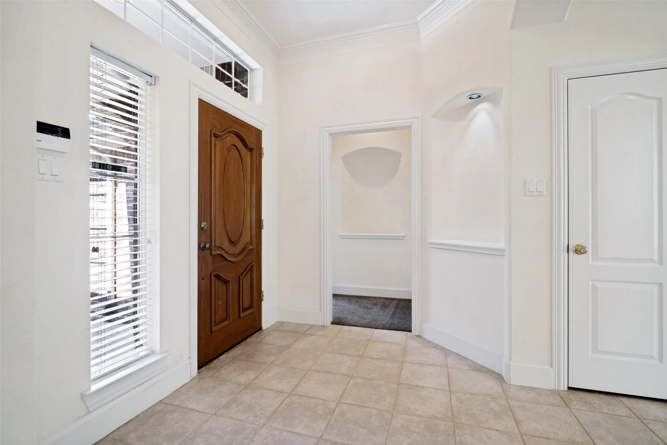 The entry boasts two custom decorative niches that enhance the beauty of this home.