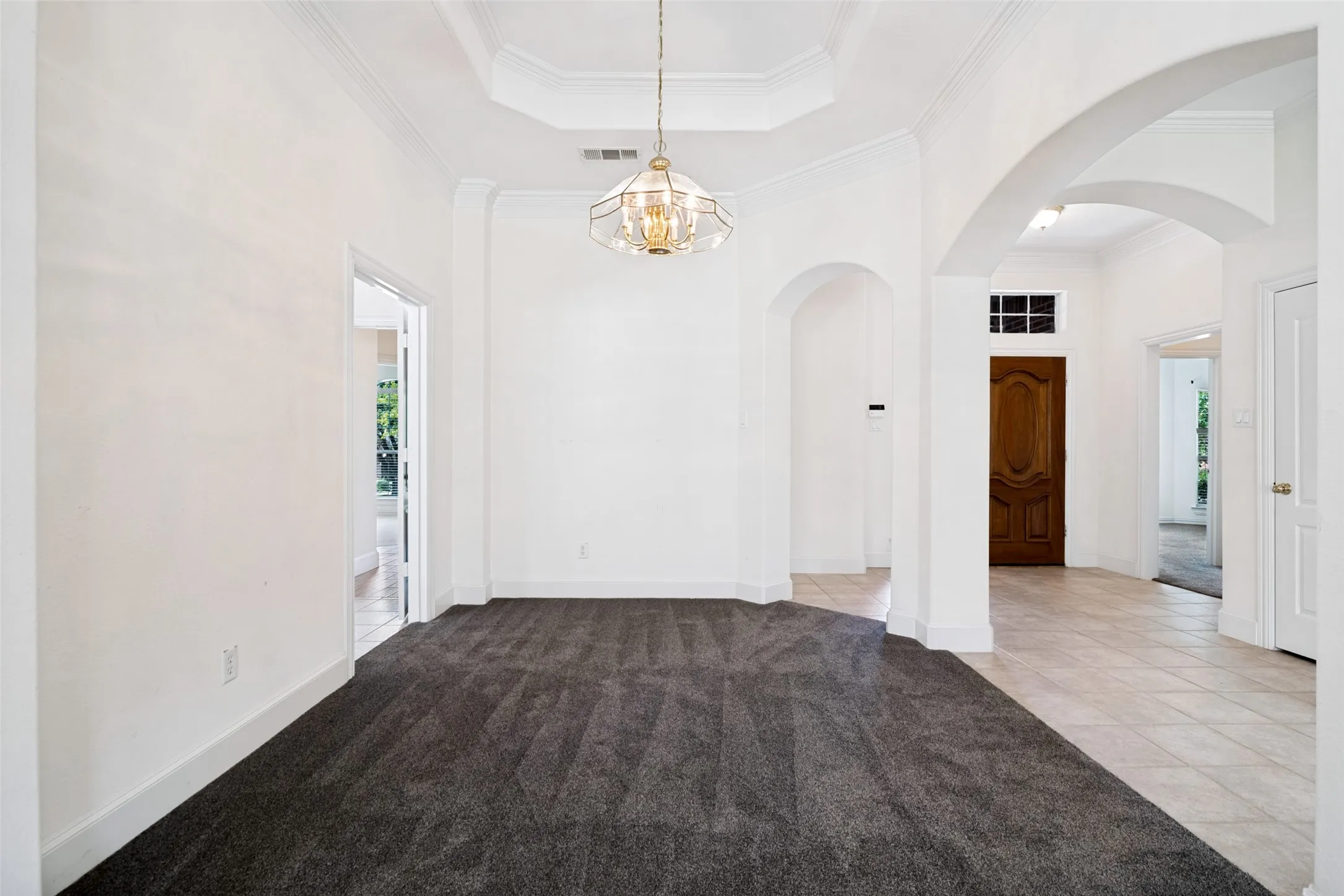 Formal dining with beautiful tray ceilings and deep crown molding.