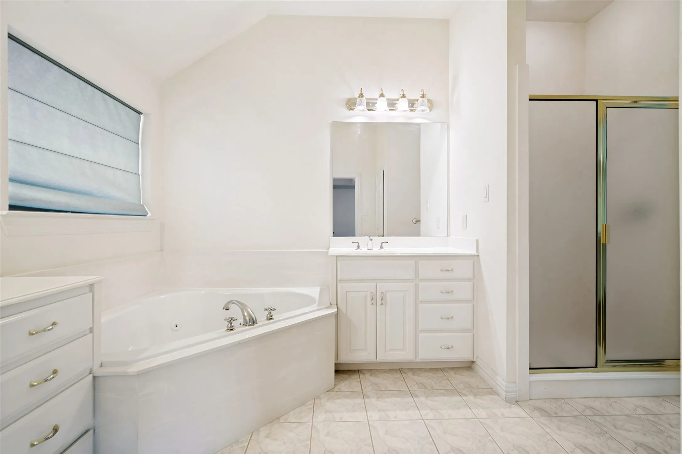 The primary bathroom has a jetted tub, separate vanities, a separate shower and a huge walk-in closet. This is a lovely place to relax and unwind at the end of the day.