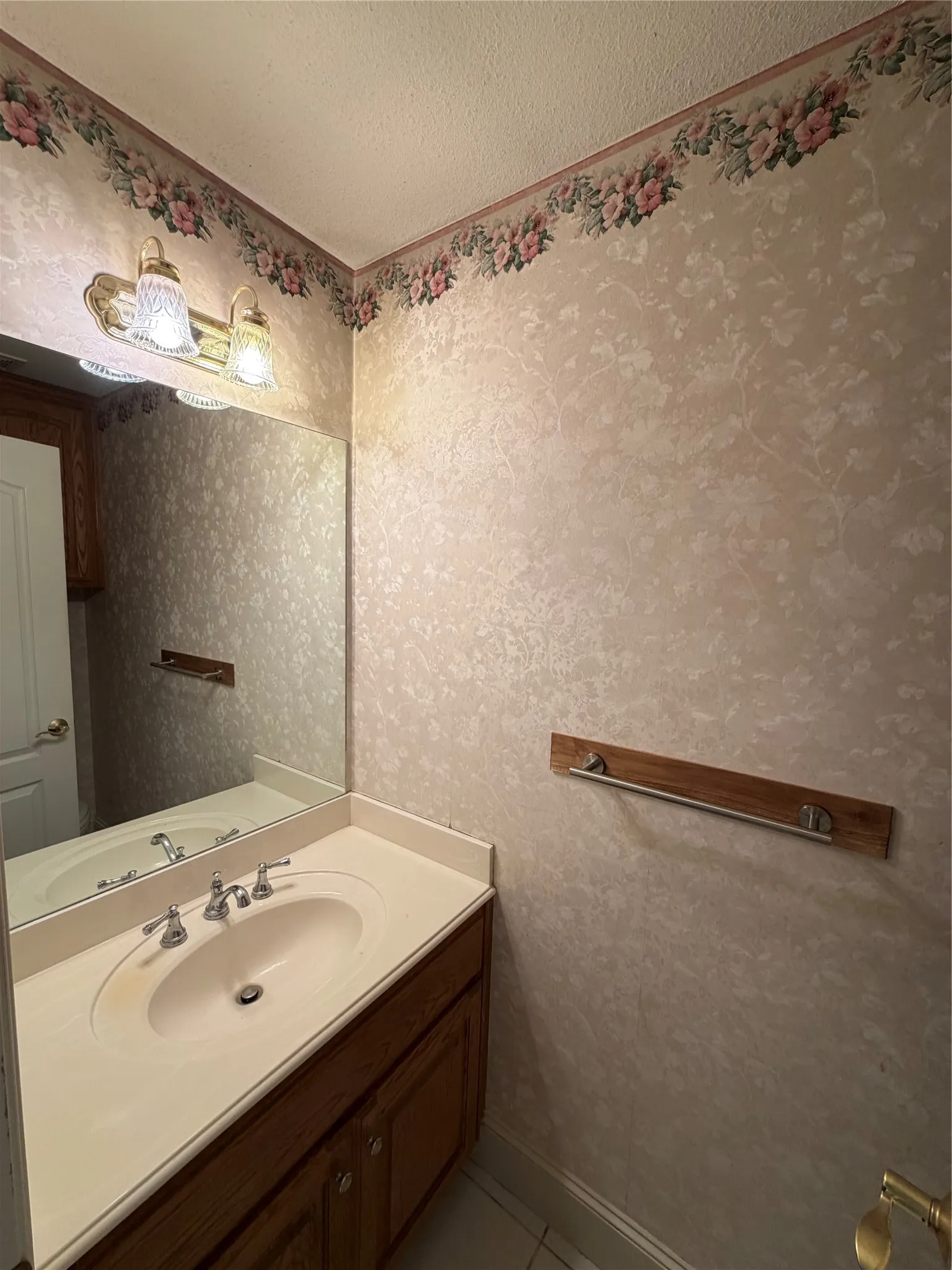 Lovely half bath is perfect for guests just off the private hallway.