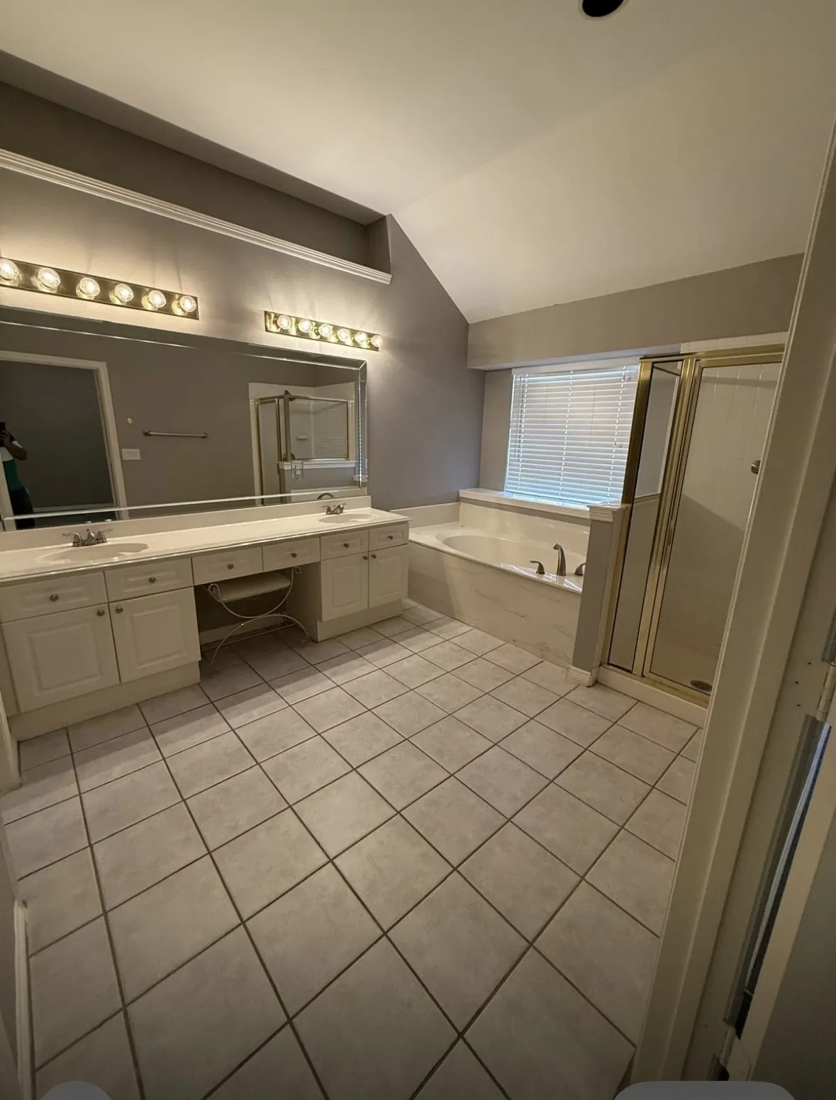 Bathroom with tile patterned flooring, vanity, lofted ceiling, and independent shower and bath