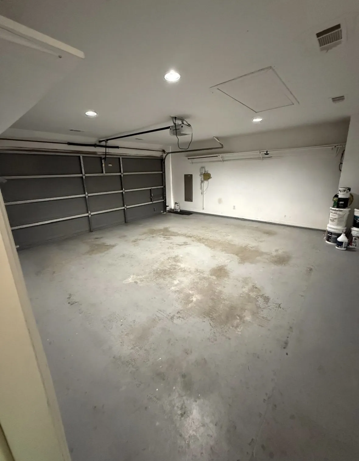 Garage featuring a garage door opener and electric panel