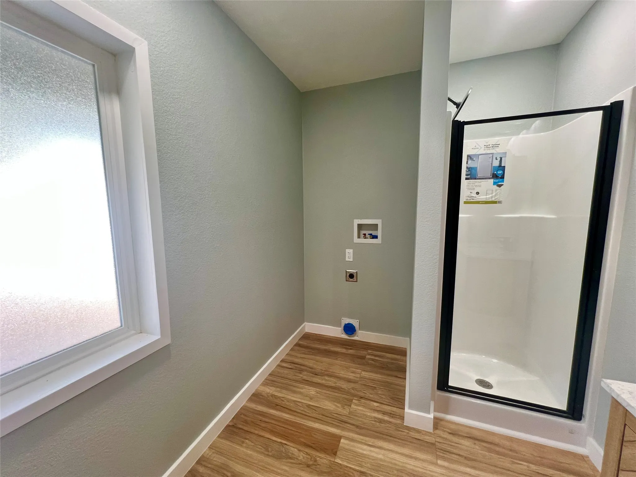 Stackable washer/dryer space in large bathroom