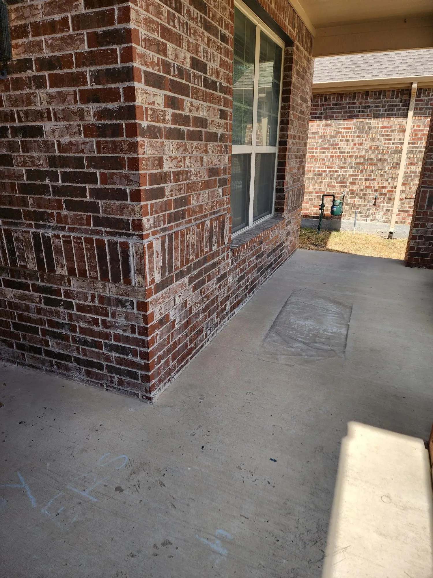 Brick exterior with concrete flooring and a multi-pane window