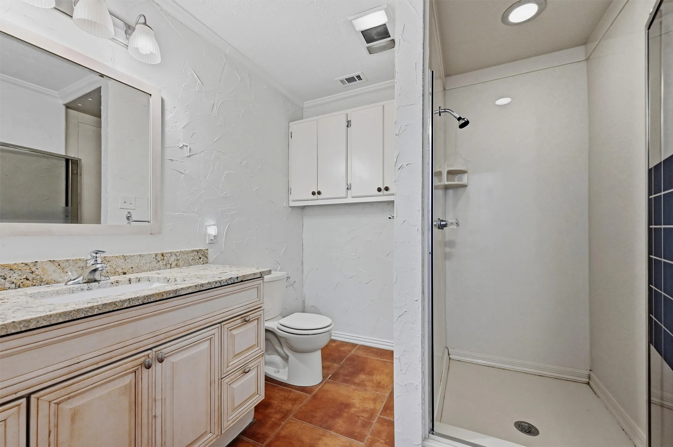 Vanity with a light-toned countertop and under-sink storage