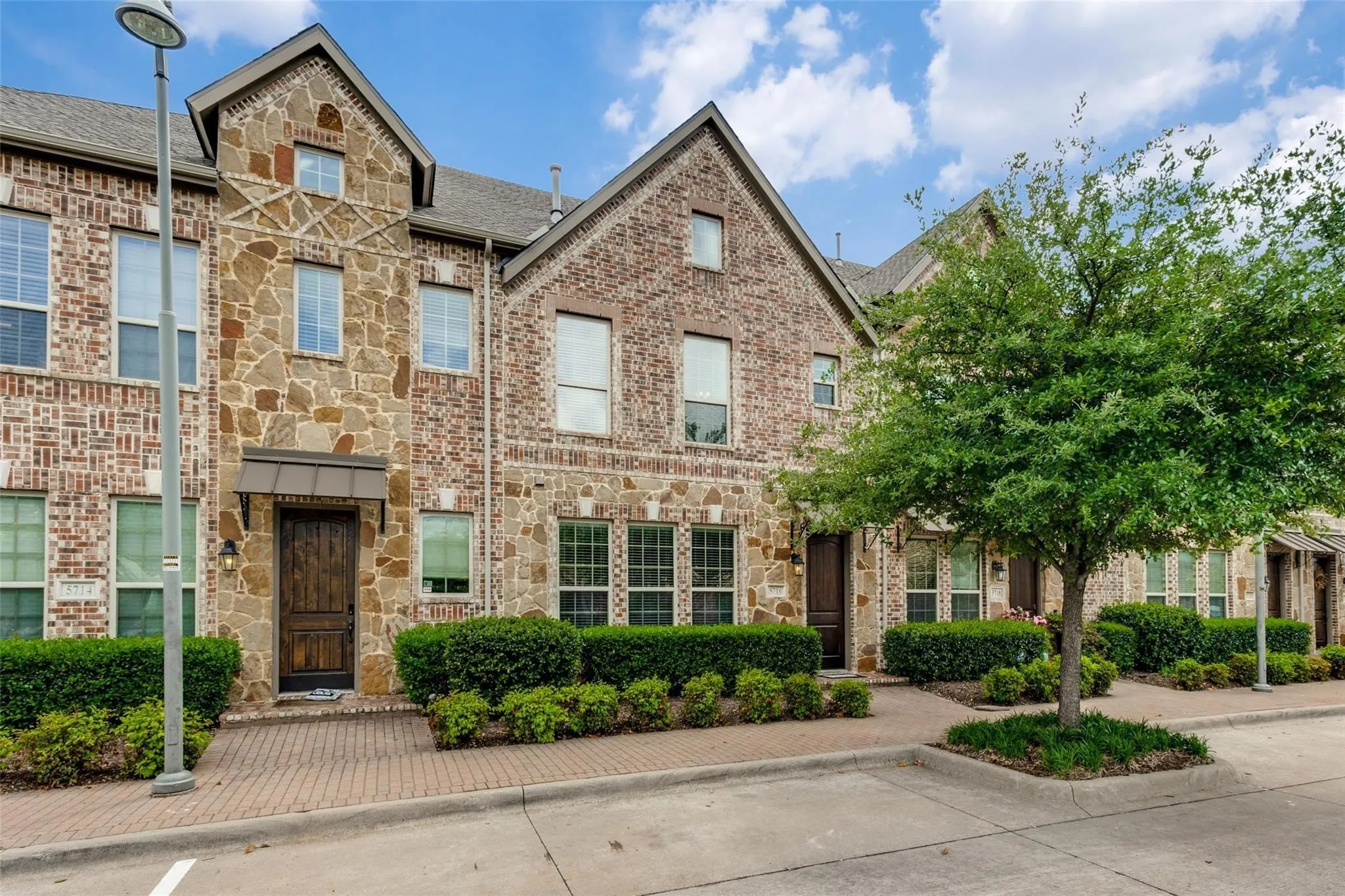 Brick and stone exterior featuring multiple windows