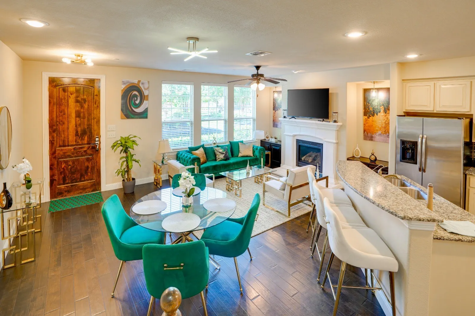 Wood-finish flooring, recessed lighting, and a fireplace with a white mantel