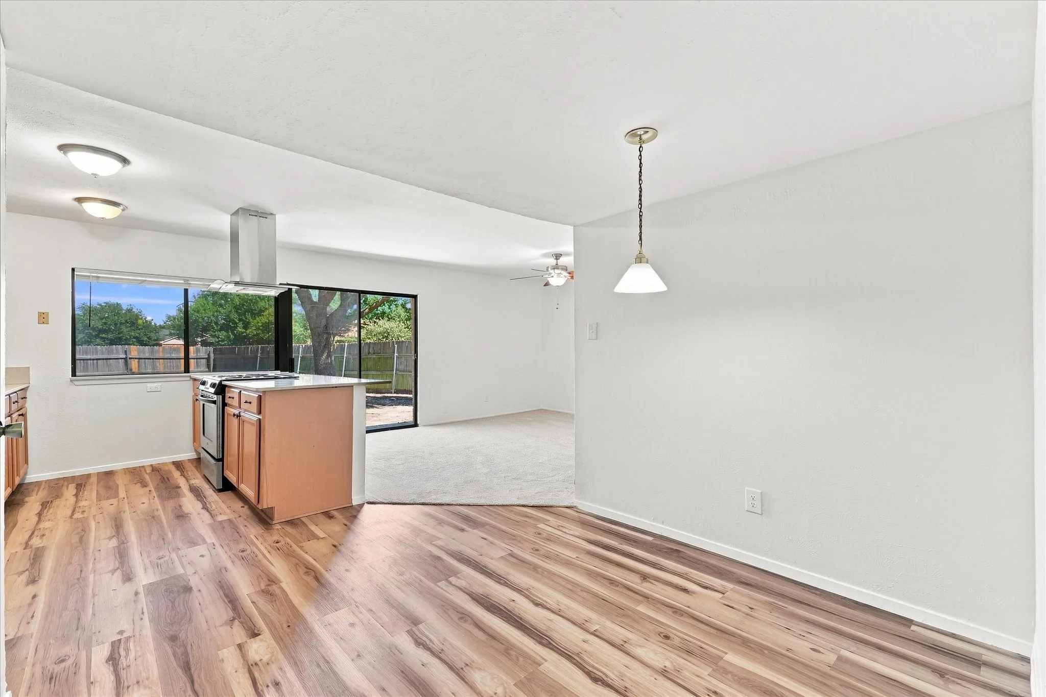 Combo breakfast area, kitchen, and den all overlook backyard