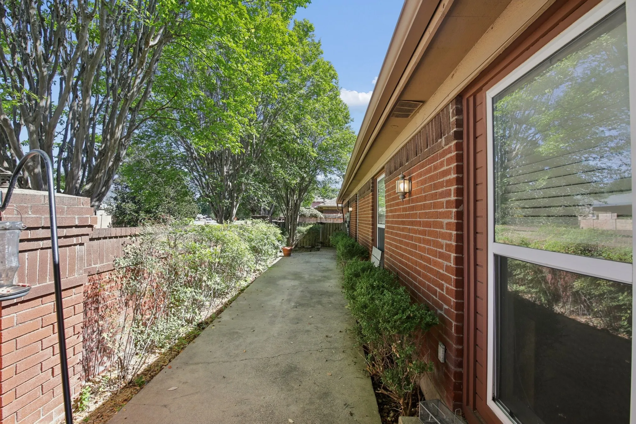 Brick exterior with multiple windows and exterior lighting fixtures
