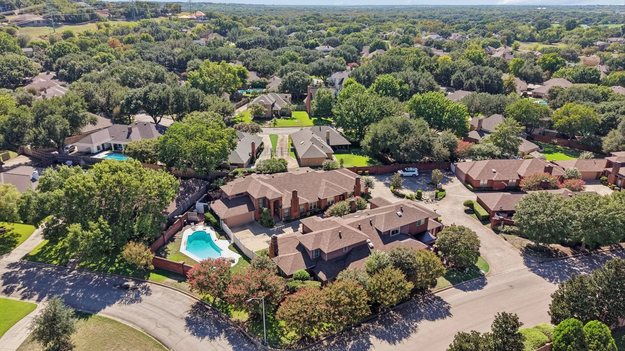 Expansive property with a private pool, surrounded by mature trees and lush landscaping