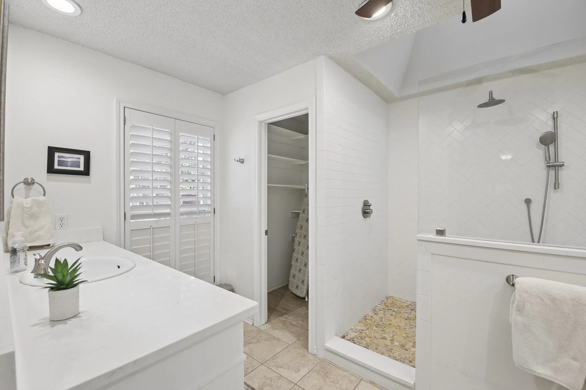 Vanity with an integrated sink, polished chrome faucet, and white countertop